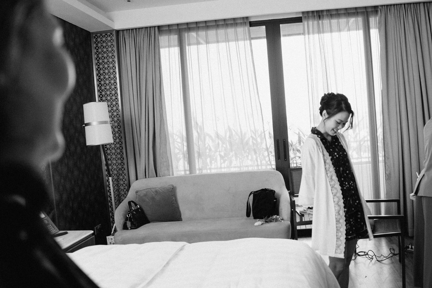Interior shots of a hotel room with natural light streaming through curtained windows.
