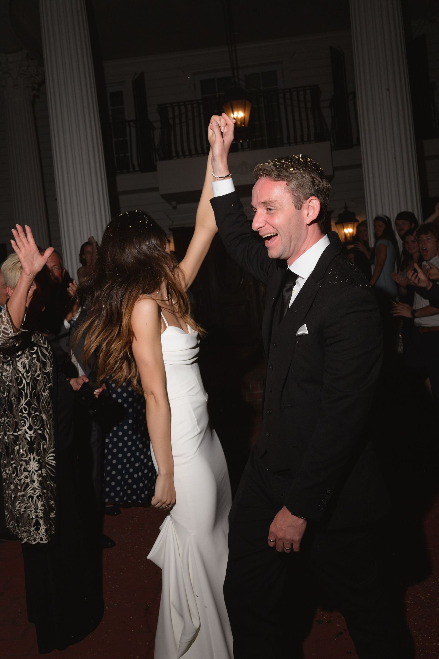 Wedding reception dance floor filled with celebration and joyful movement.