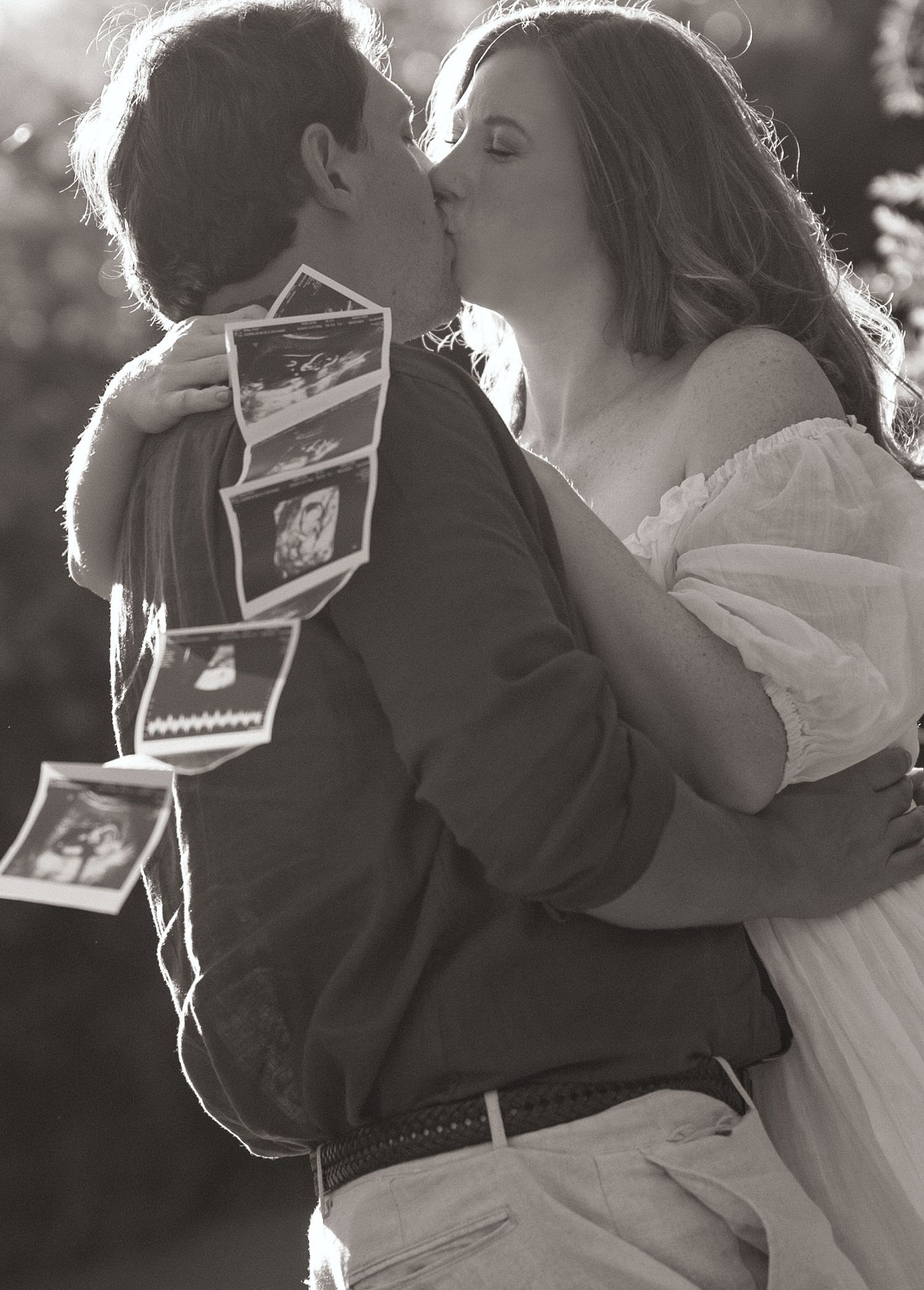 Series of romantic black and white wedding photos showing couple embracing while holding vintage photographs.