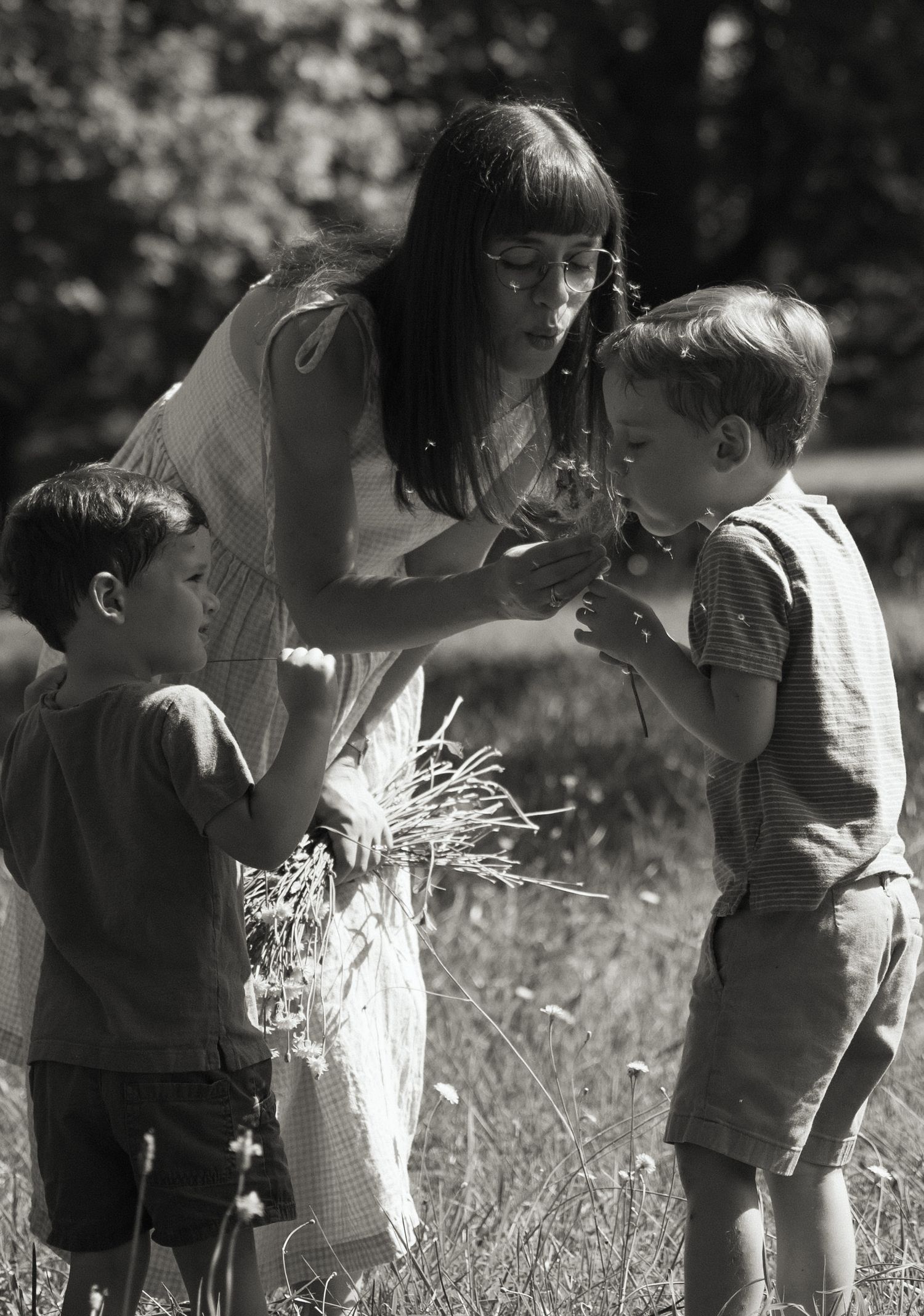 Vintage black and white photographs of children exploring nature in a field.