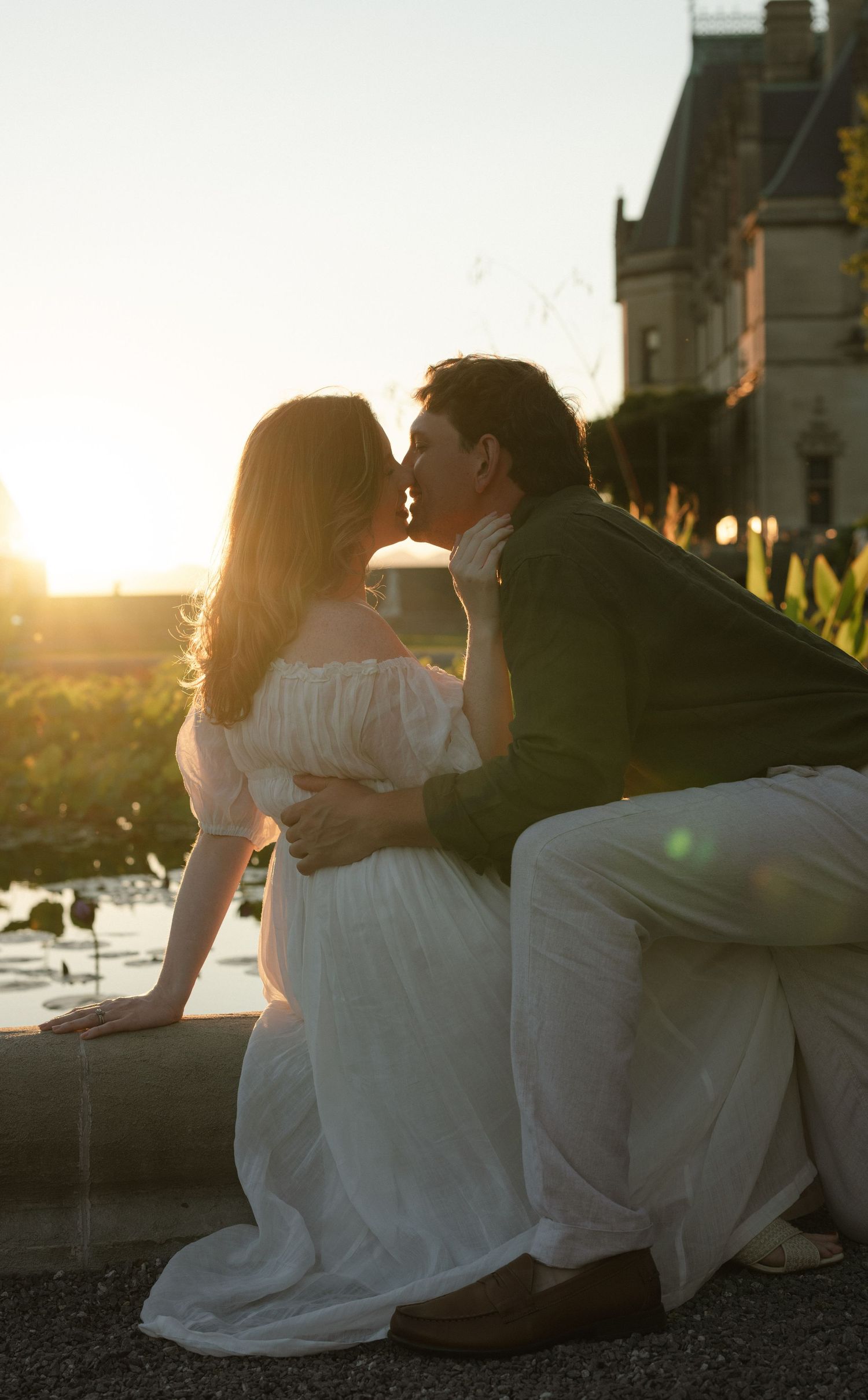 Romantic sunset photos of a couple resting together outdoors with golden light.