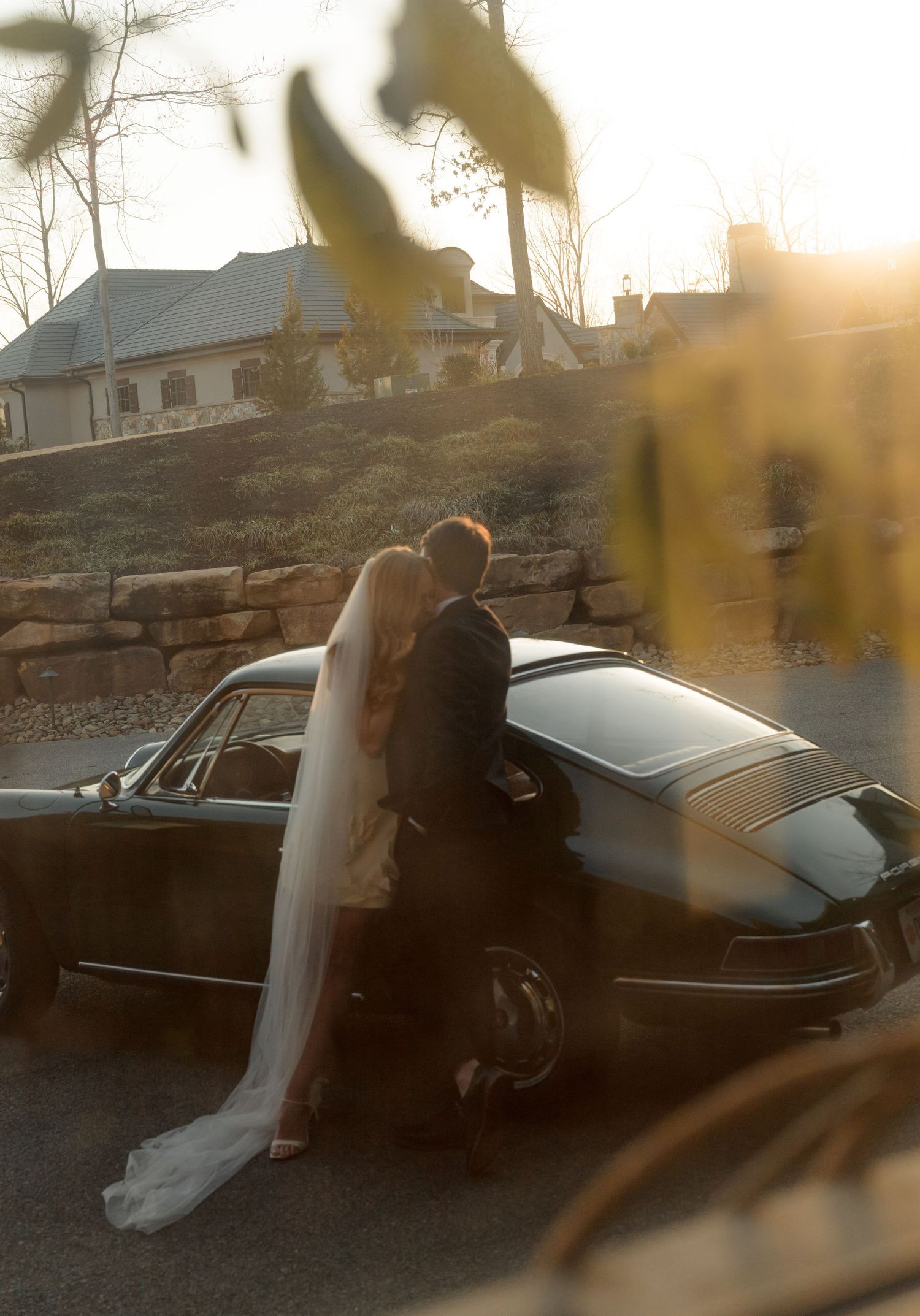 Romantic sunset moment captured with vintage car silhouette.