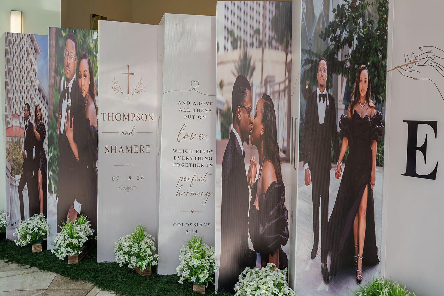 Elegant wedding photo display backdrop featuring Thompson and Shamere with floral decorations and romantic couple portraits.