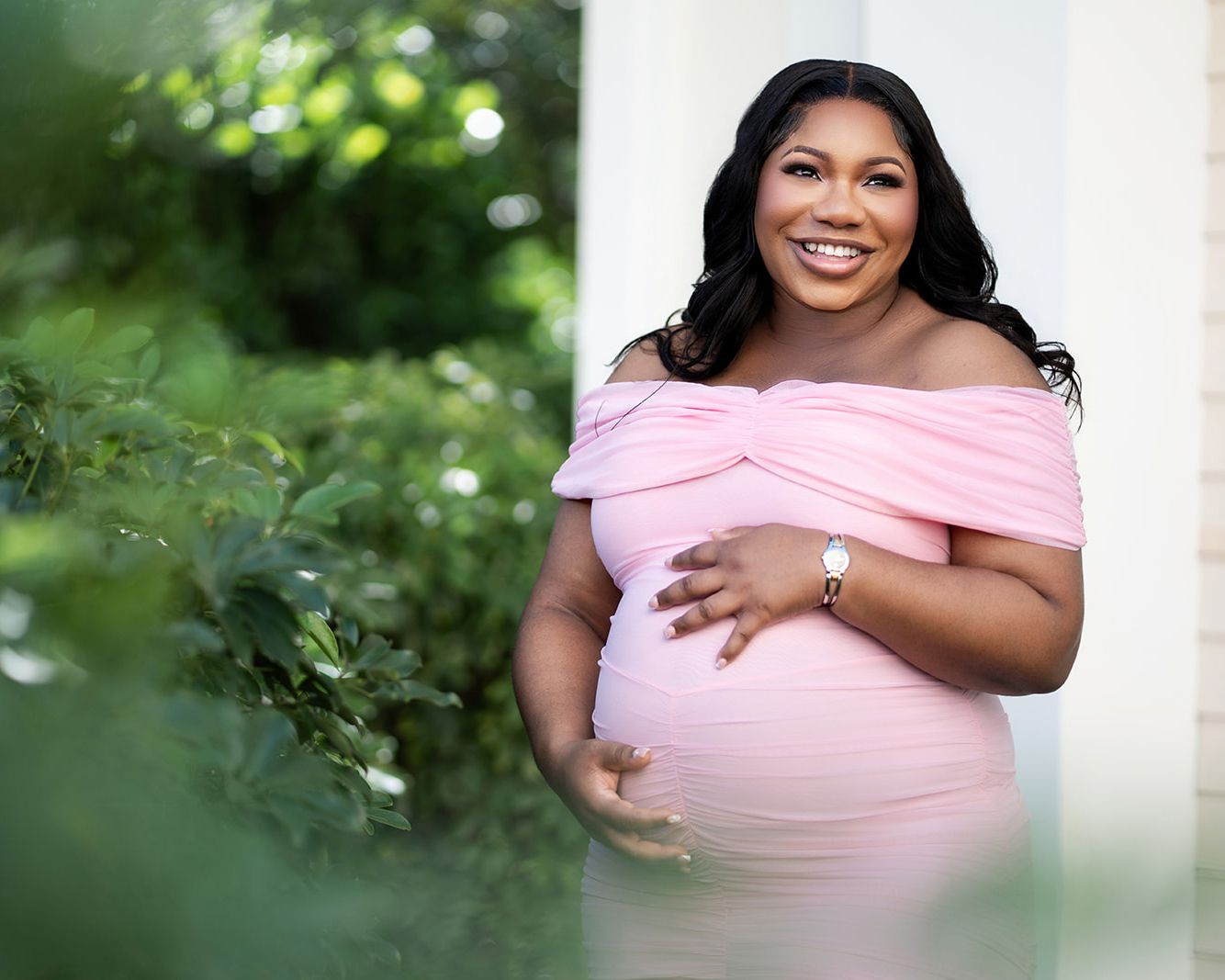 Relaxed maternity portrait in a soft pink dress