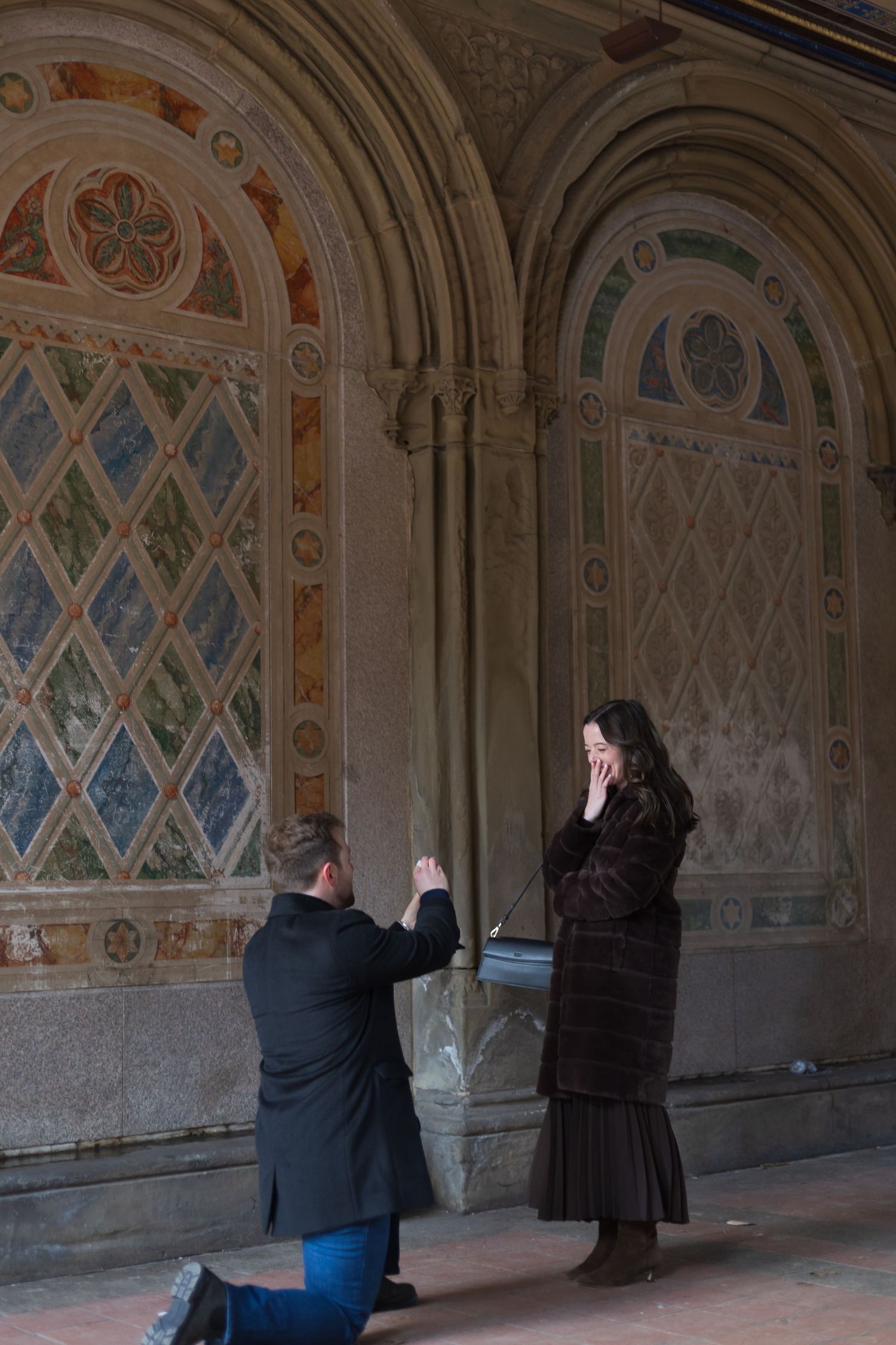Surprise marriage proposal under the Minton tiles at Bethesda Terrace in Central Park NYC.