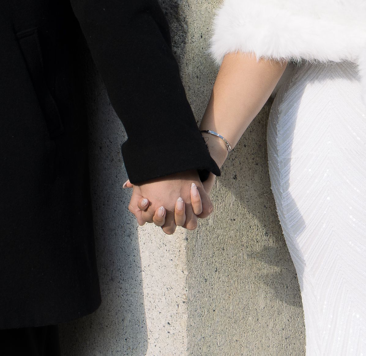 Close up of a couple holding hands on their NYC Wedding day