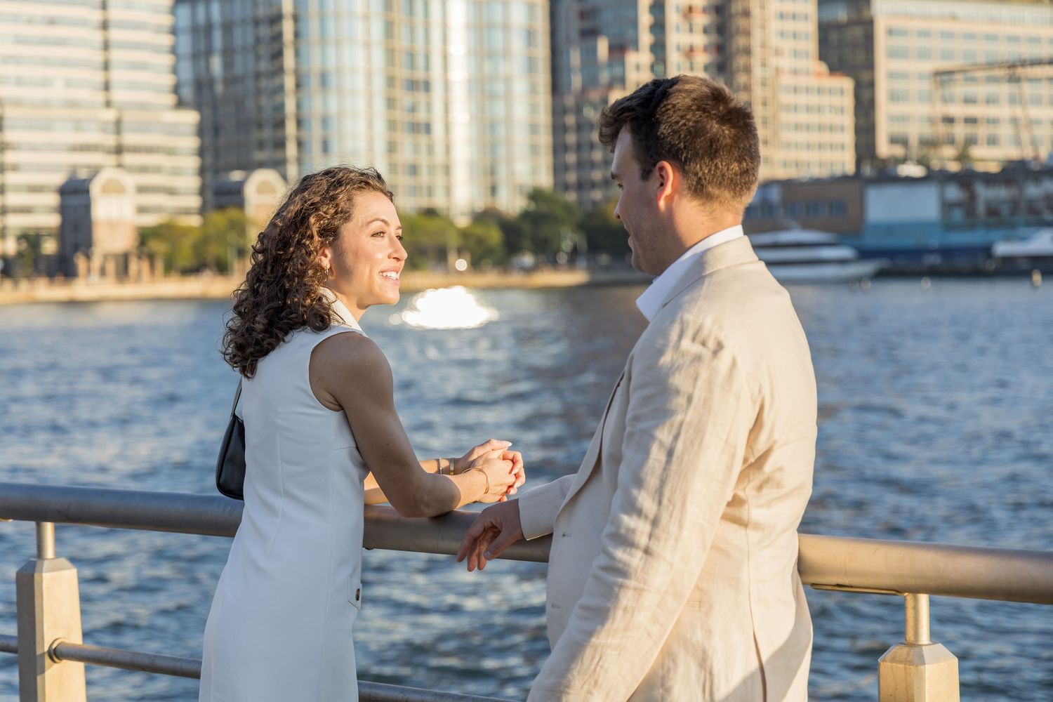 Couple looking at each other on the railing of pier 45 west village engagement photoshoot nyc
