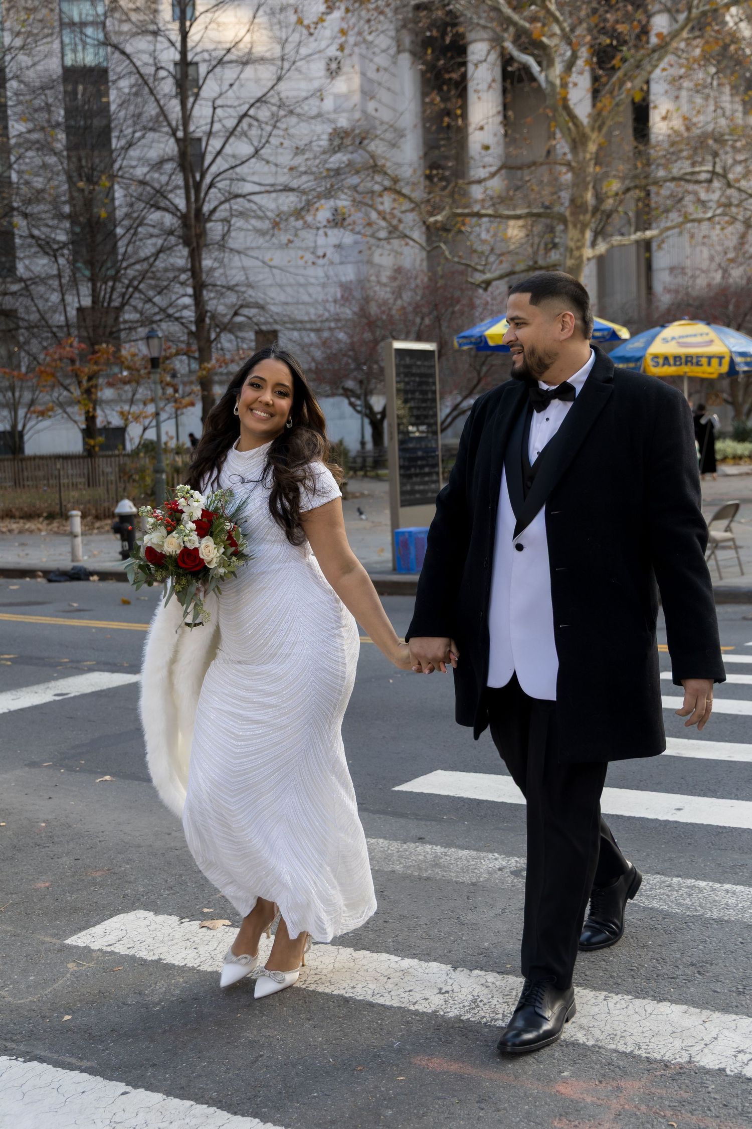 Couple walking across the street outside the Manhattan Marriage Bureau before their ceremony