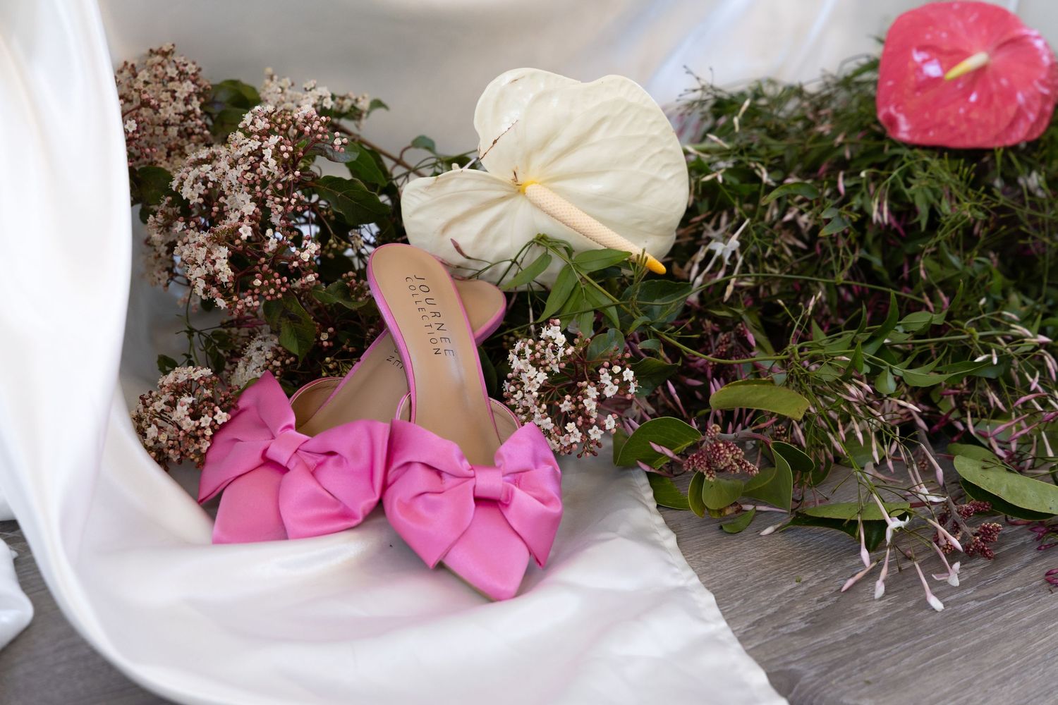A series of pink and white floral arrangement with pink heels.