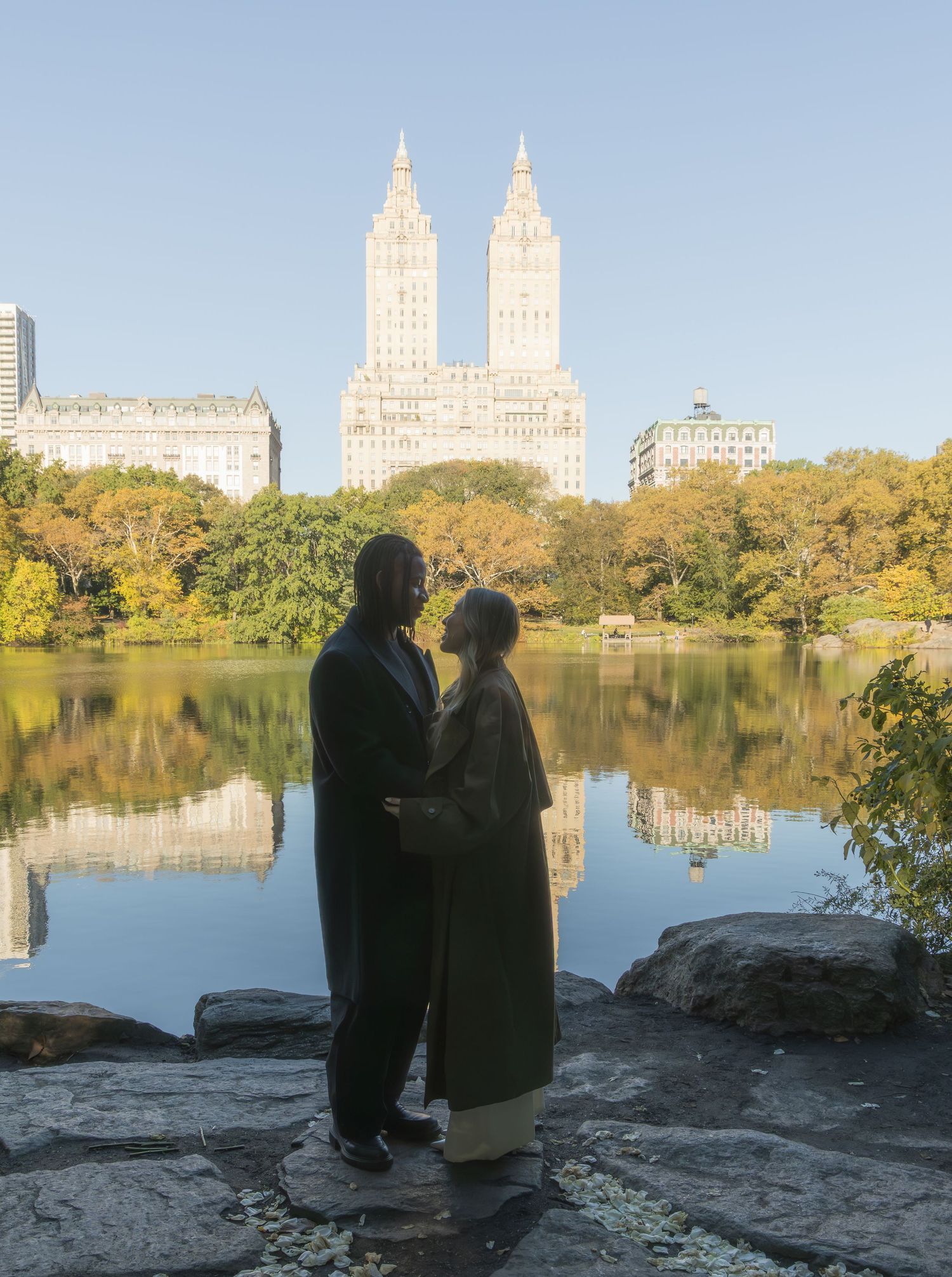 Couple portrait by The Lake at Central Park with the San Remo Apartment building in the background