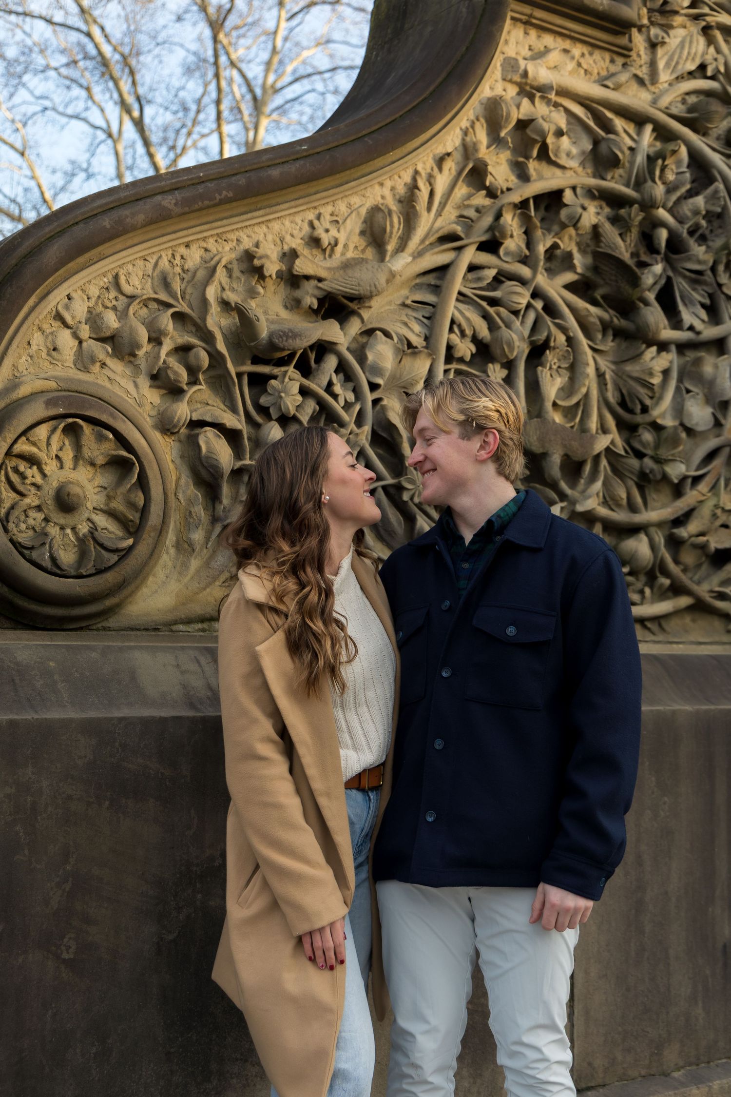 Couple portraits of them looking at each other at the steps of Bethesda Terrace