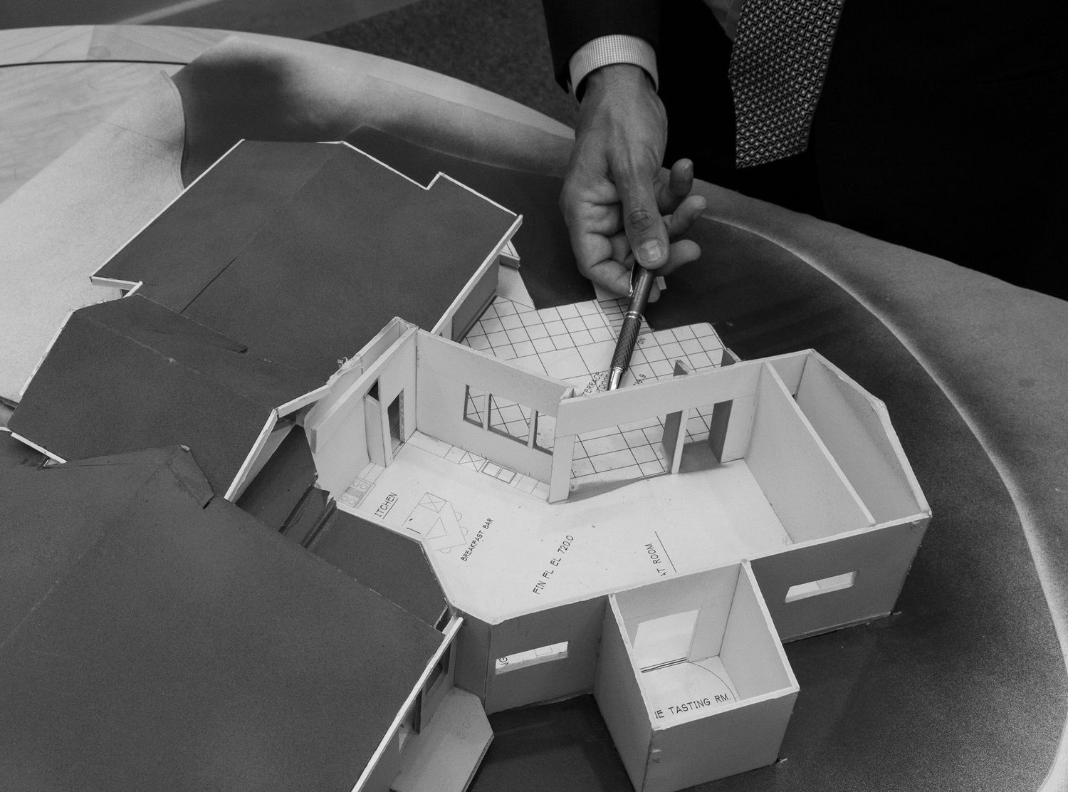 Black and white architectural model photos showing progressive assembly stages of a small scale building structure.