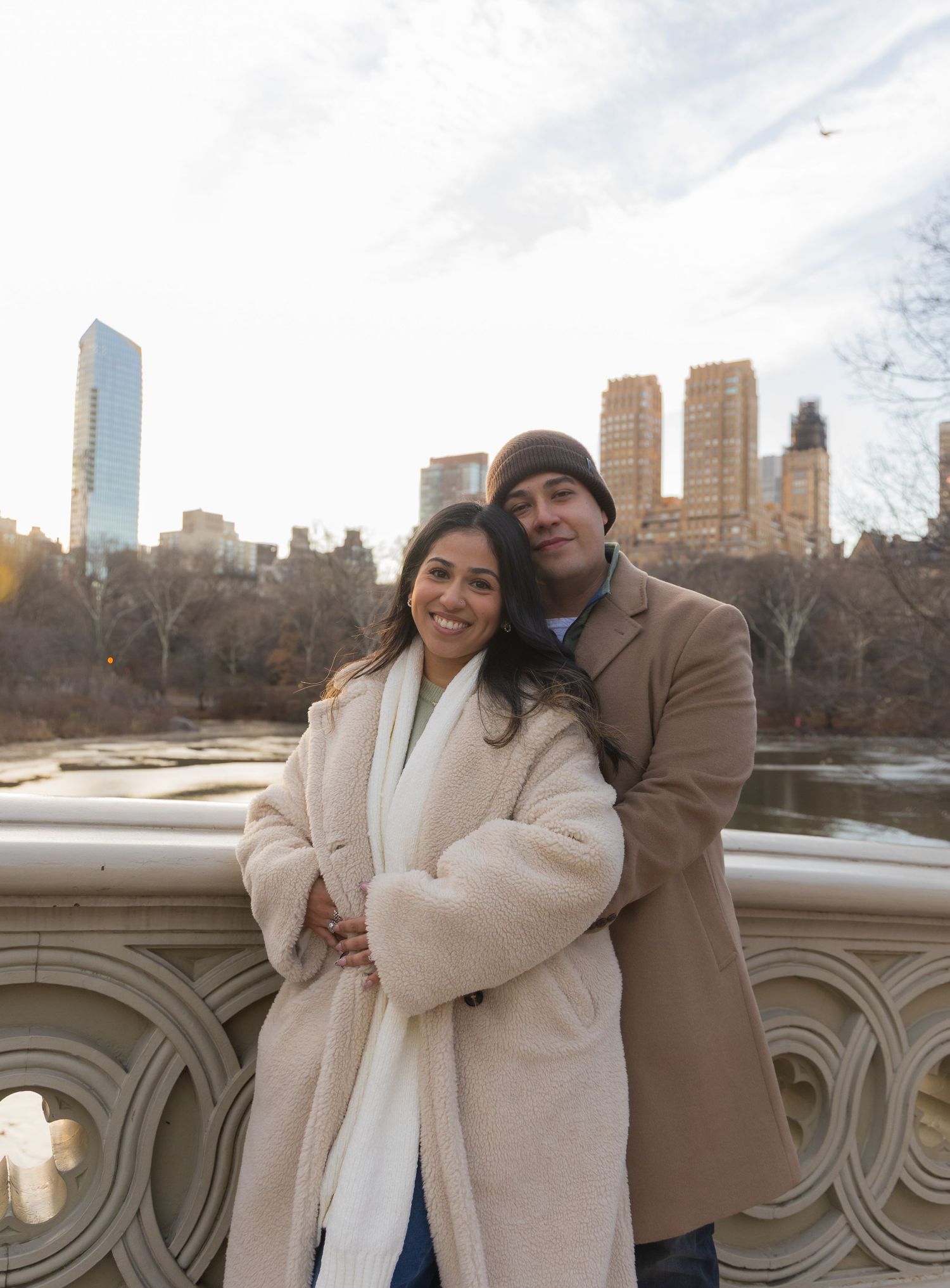 Couple portrait on the Bow Bridge after their proposal session at the San Remo Outlook by The Lake in Central park