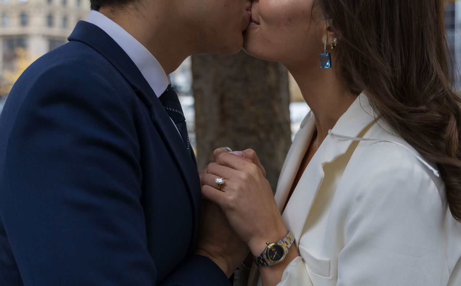 Close up of a couple kissing with their ring