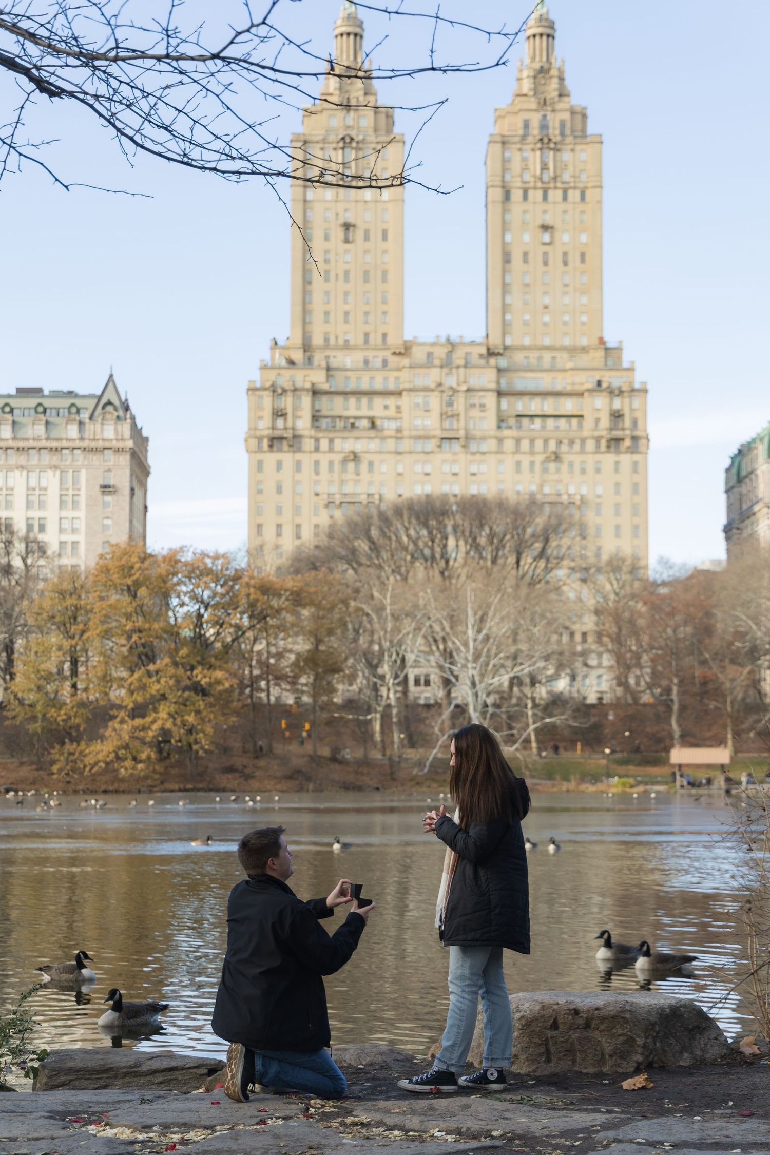 Proposal moment by The Lake at Central Park with the San Remo Apartment building in the background
