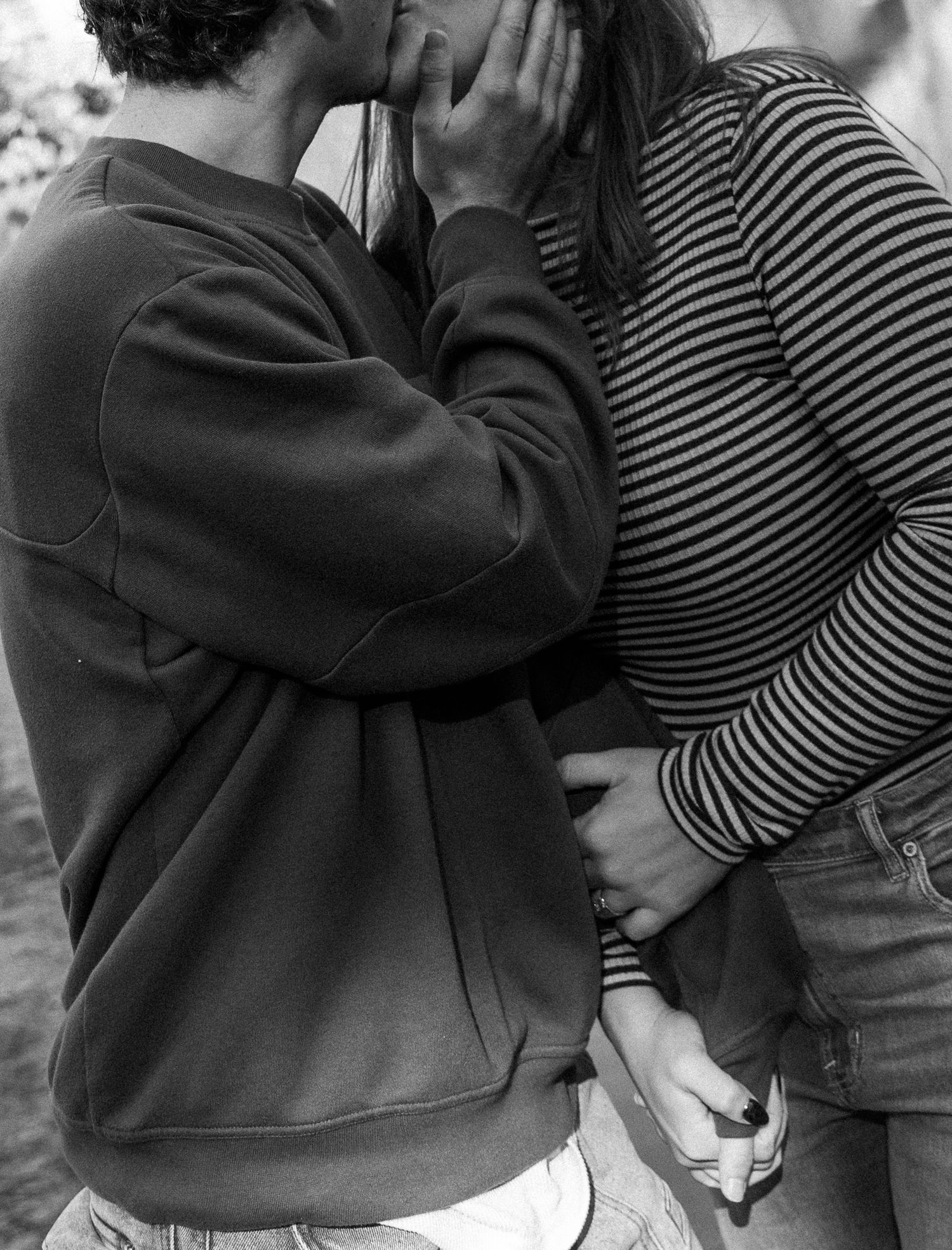 A black and white photo showing two people holding hands in different close-up angles.