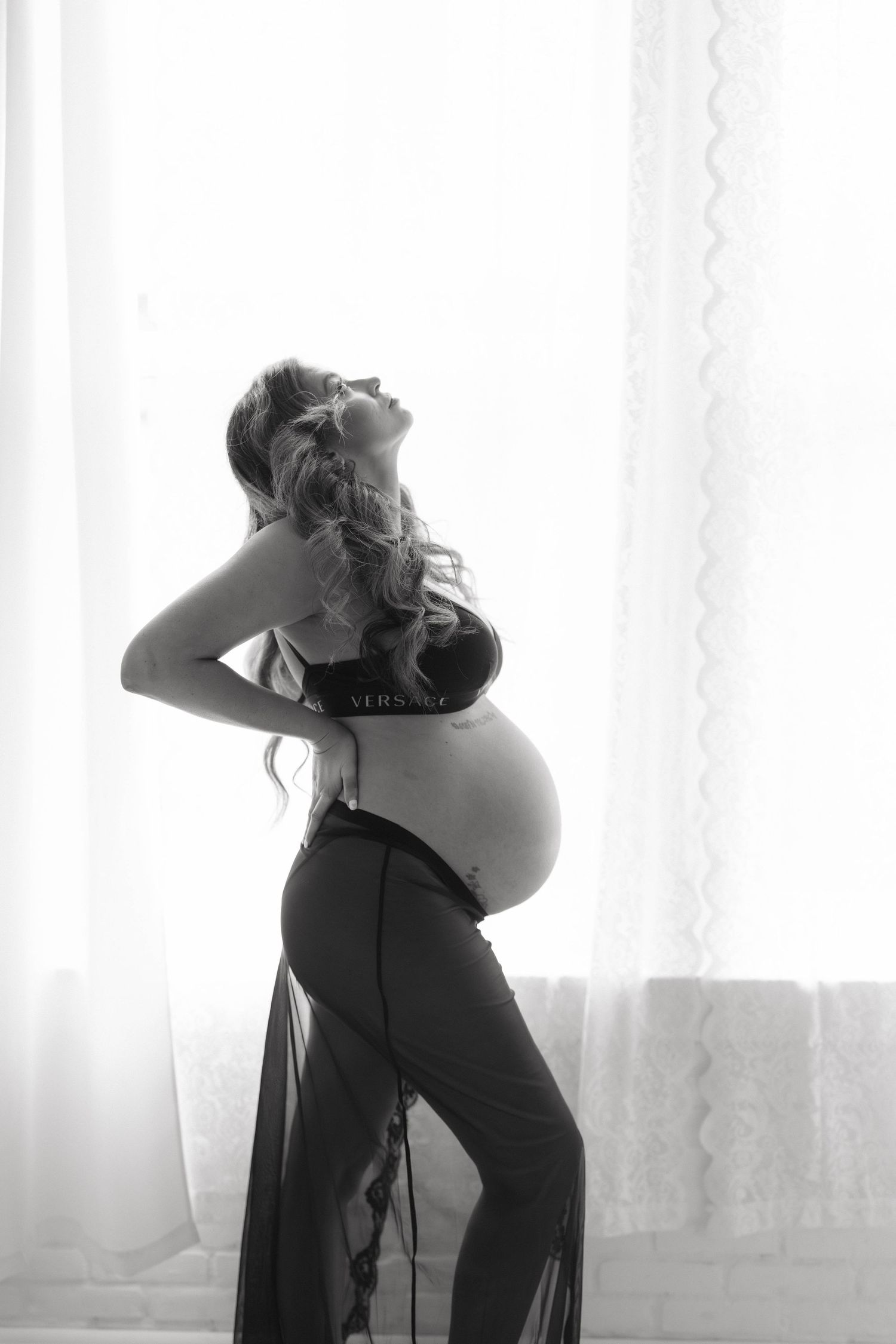Black and white artistic photo series showing silhouetted figures in intimate poses against a bright window backdrop.