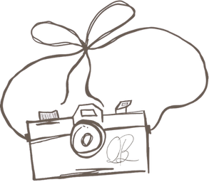 Hand drawn sketch of a vintage camera with decorative bow.