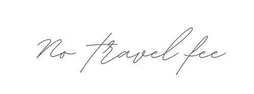 Stylish handwritten text saying 'No travel fee' in cursive script on white background.