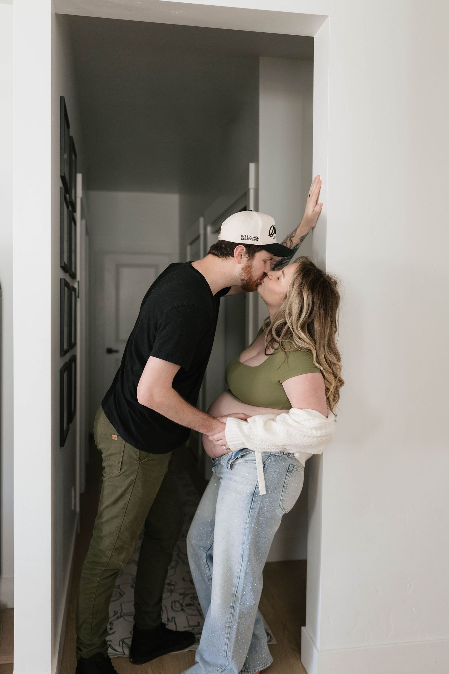A couple shares a romantic moment in a hallway.