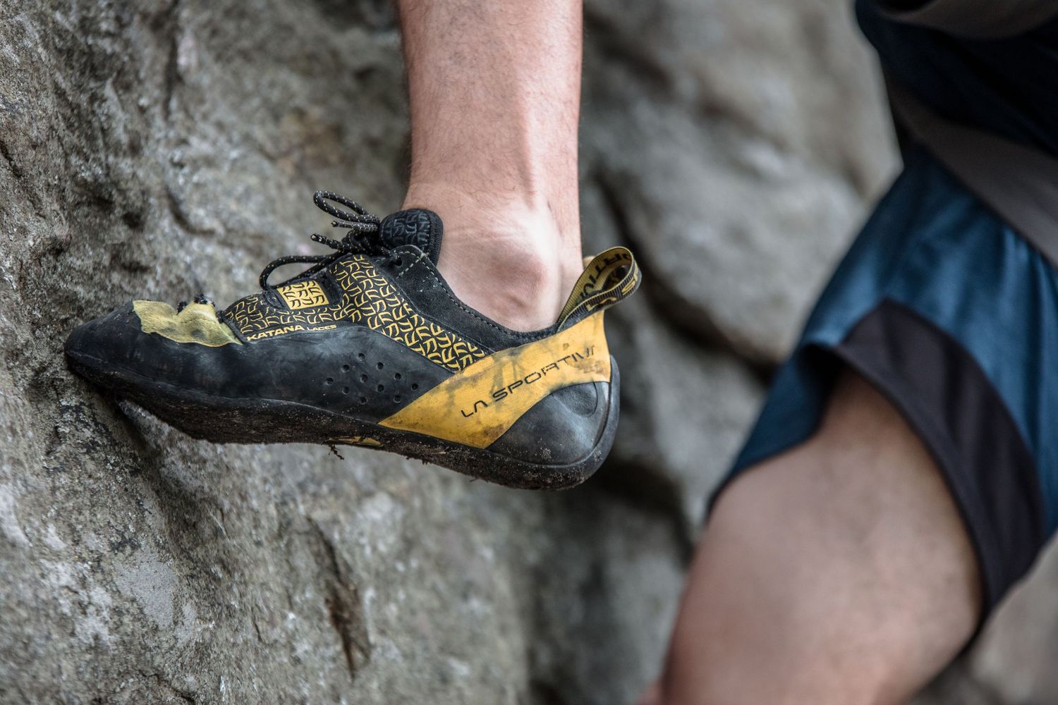 La Sportiva climbing shoe on limestone rock surface during rock climbing.