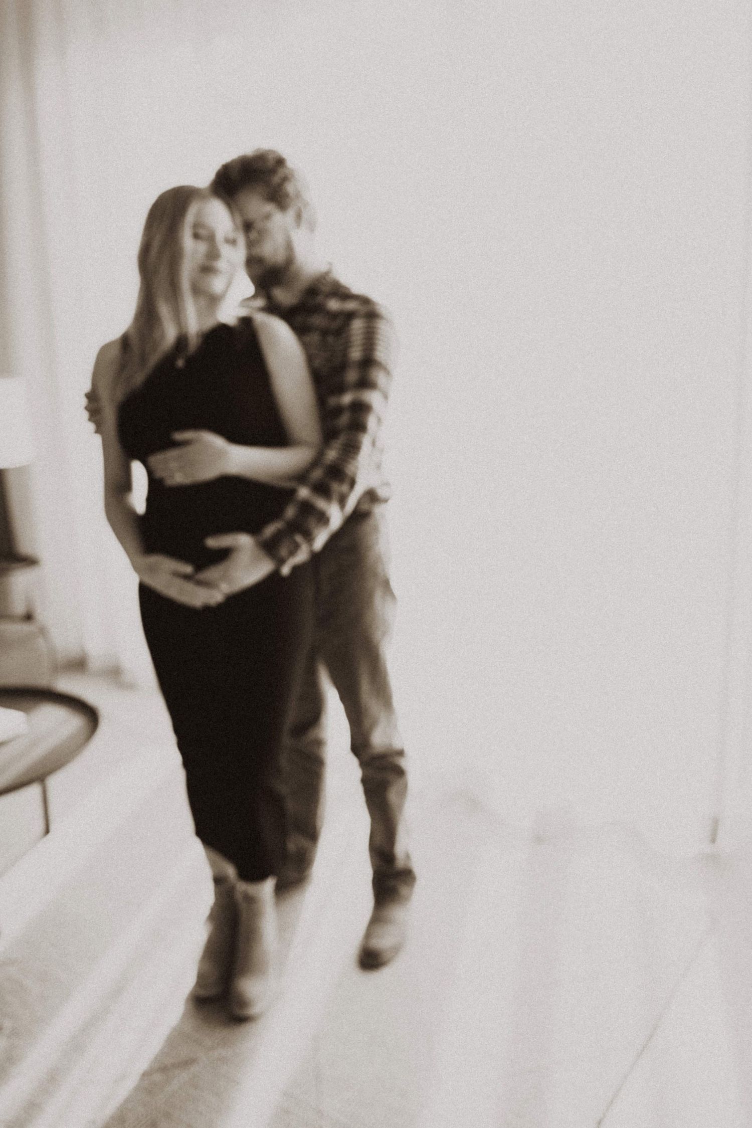 A sequence of blurred motion dance photos in black and white.