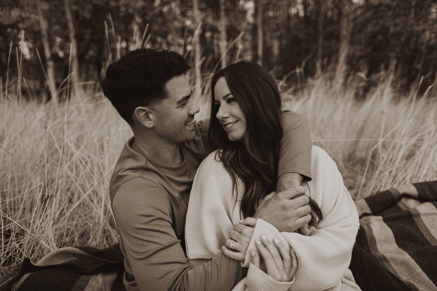 An intimate black and white portrait session in a natural outdoor setting.