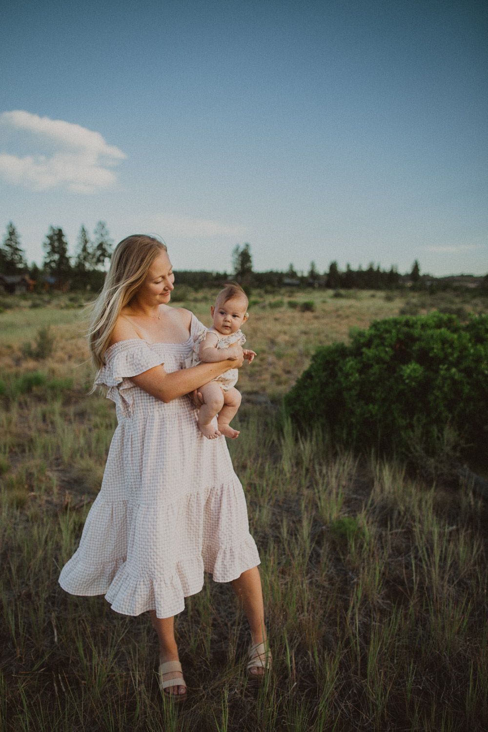 Natural light photography session in a desert landscape with white flowing dresses.