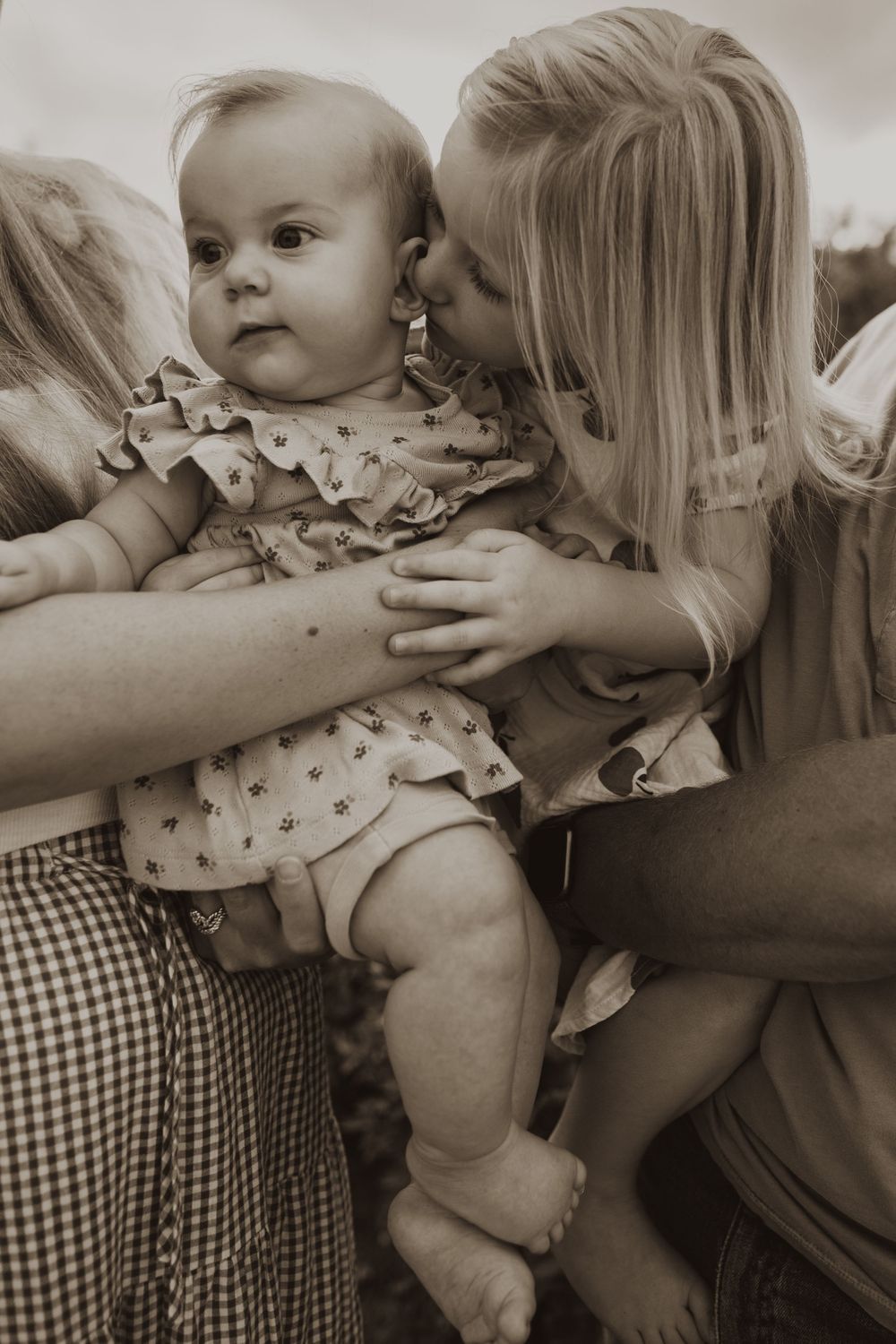 A series of intimate black and white photos showing tender moments between parent and child in a loving embrace.