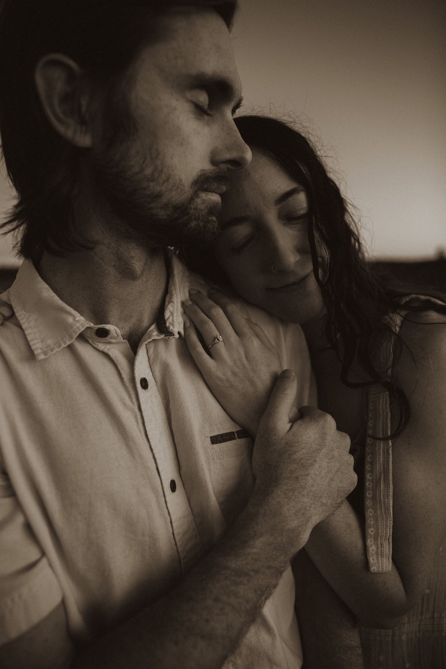 A sepia-toned series of intimate moments between a couple in natural lighting.