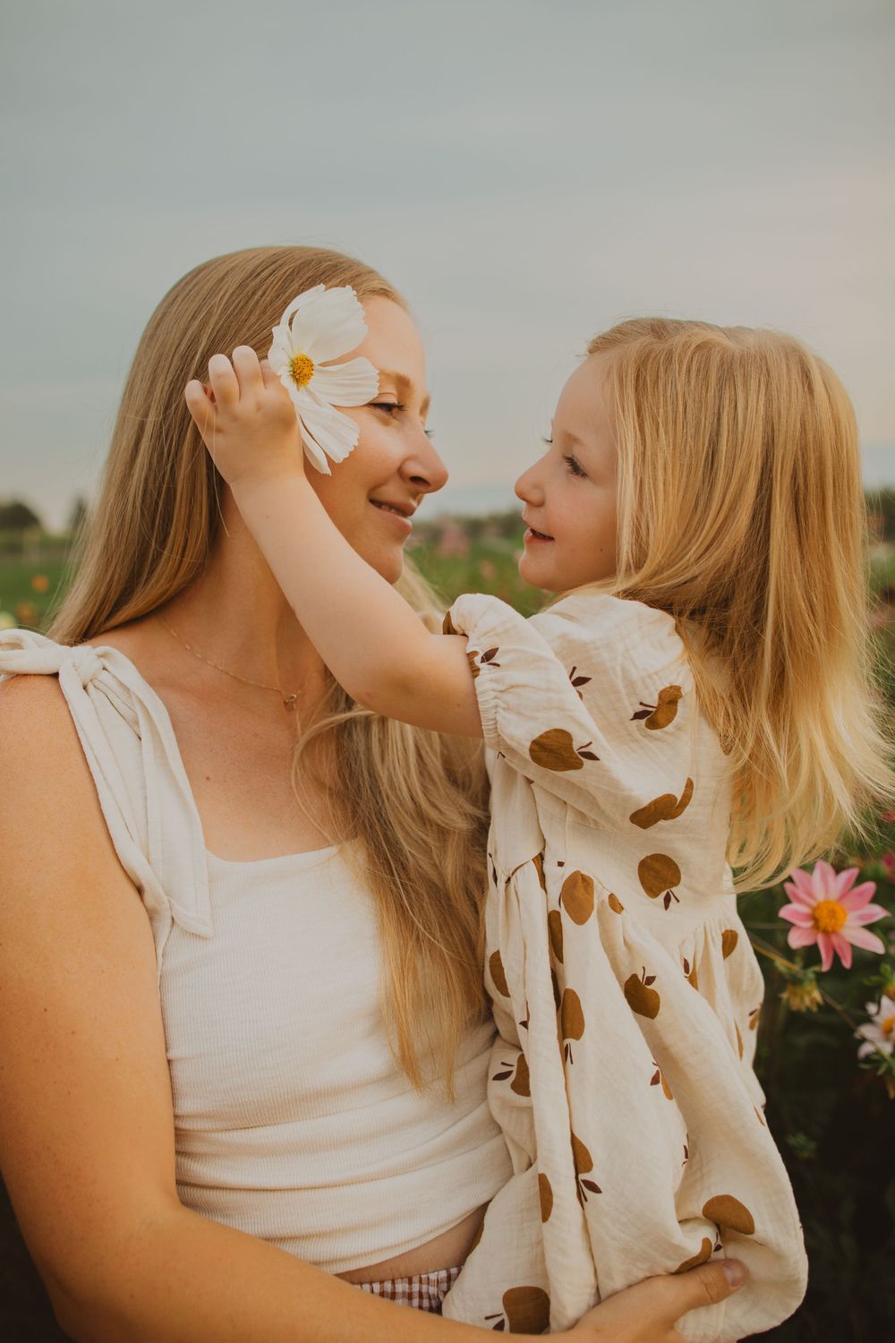 Joyful outdoor portraits taken in a flower garden during golden hour.