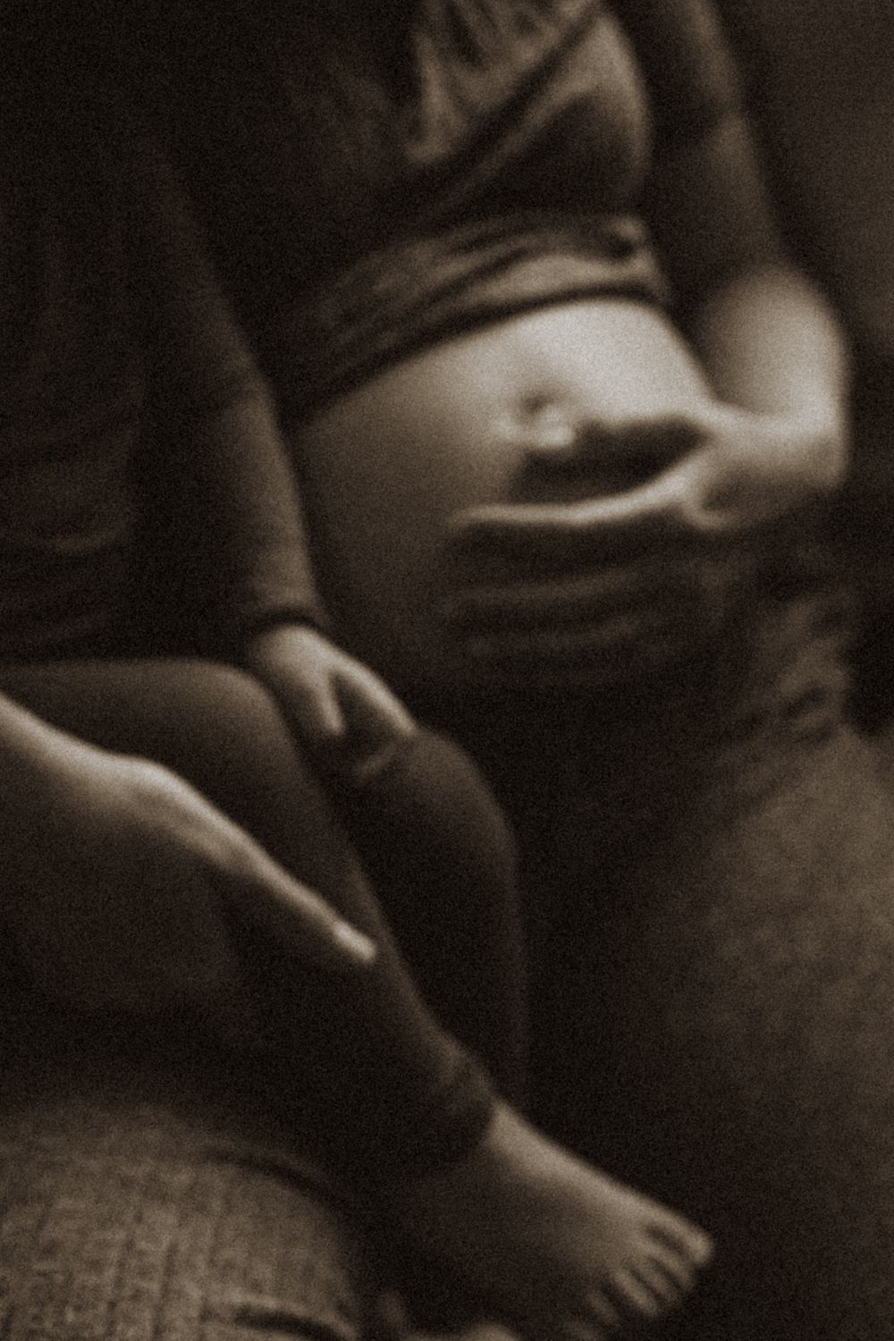 Intimate black and white maternity photos with soft focus and gentle poses.