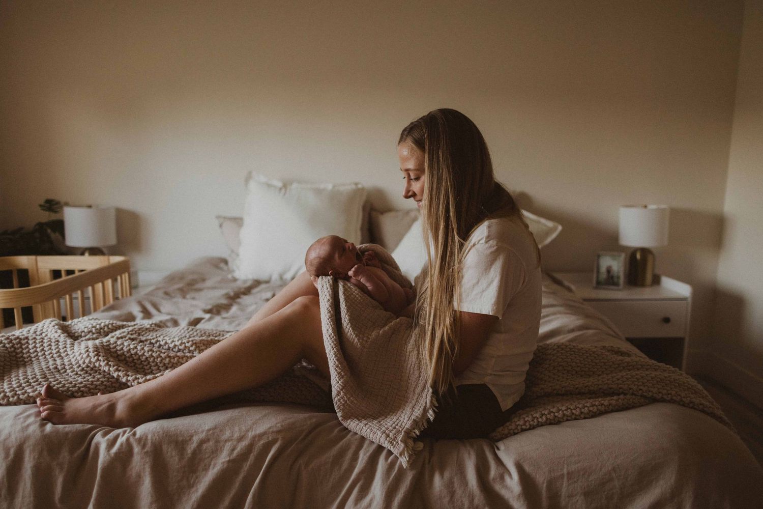 Natural light photography capturing quiet moments in a bedroom setting.