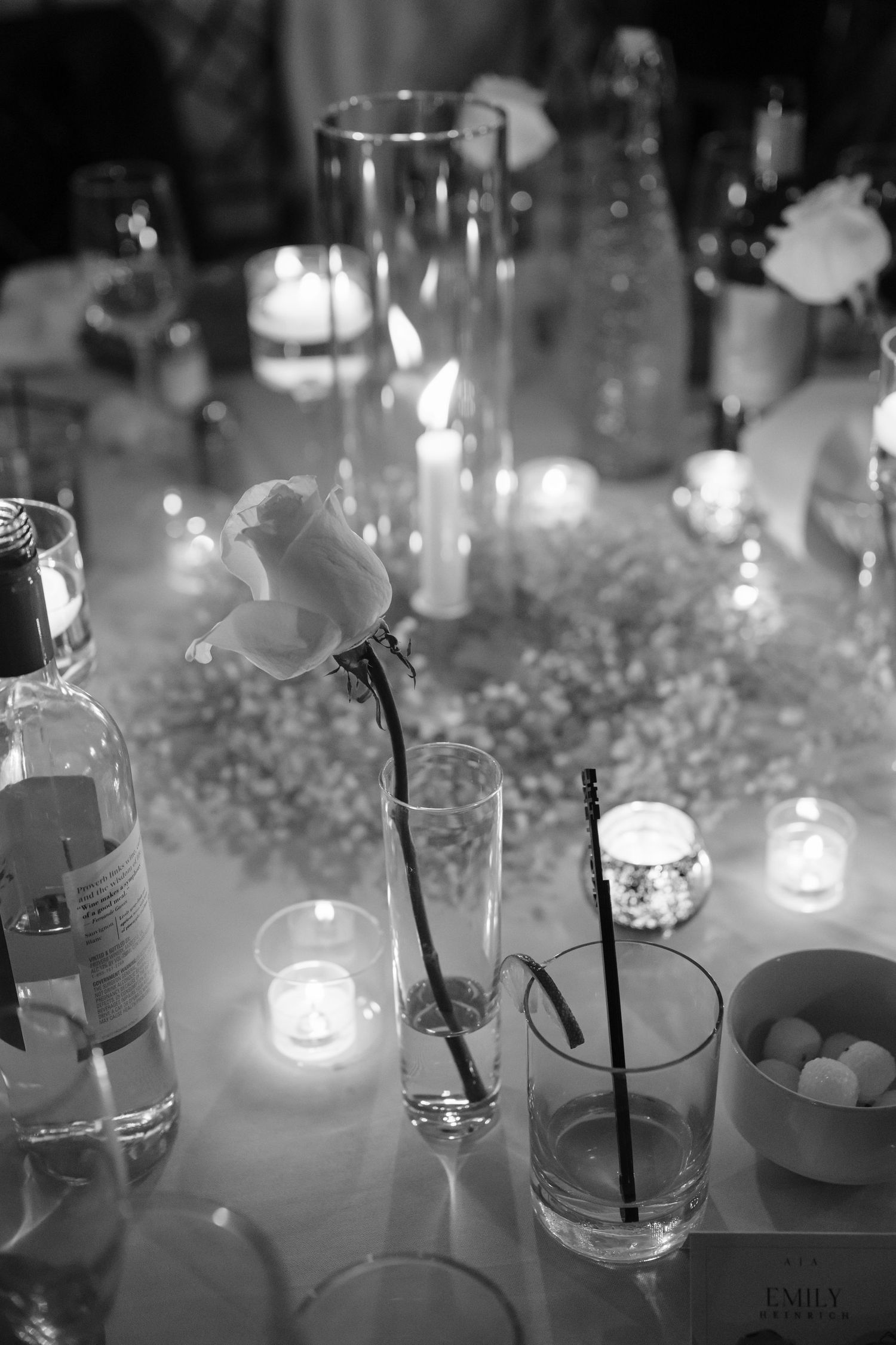 Elegant wedding reception table setting with candlelight and glassware creating a romantic ambiance.