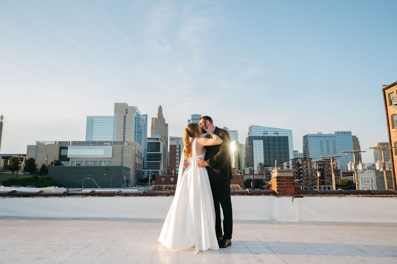 Panoramic sequence of wedding photos showing a couple posing against a city skyline and waterfront backdrop.