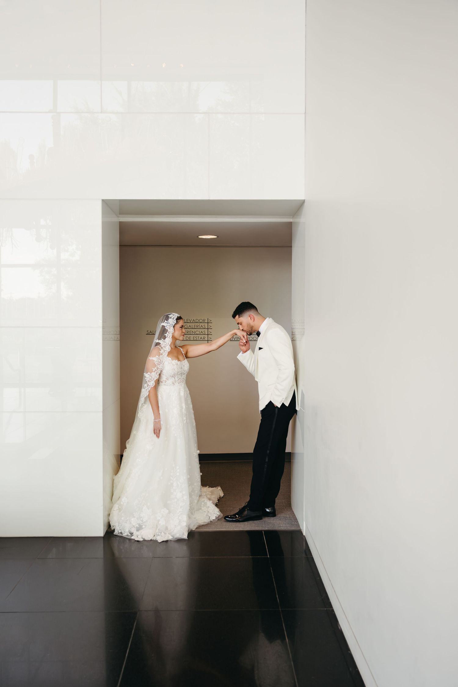A sequence of four wedding photos showing a couple posing playfully in a minimalist white hallway setting.