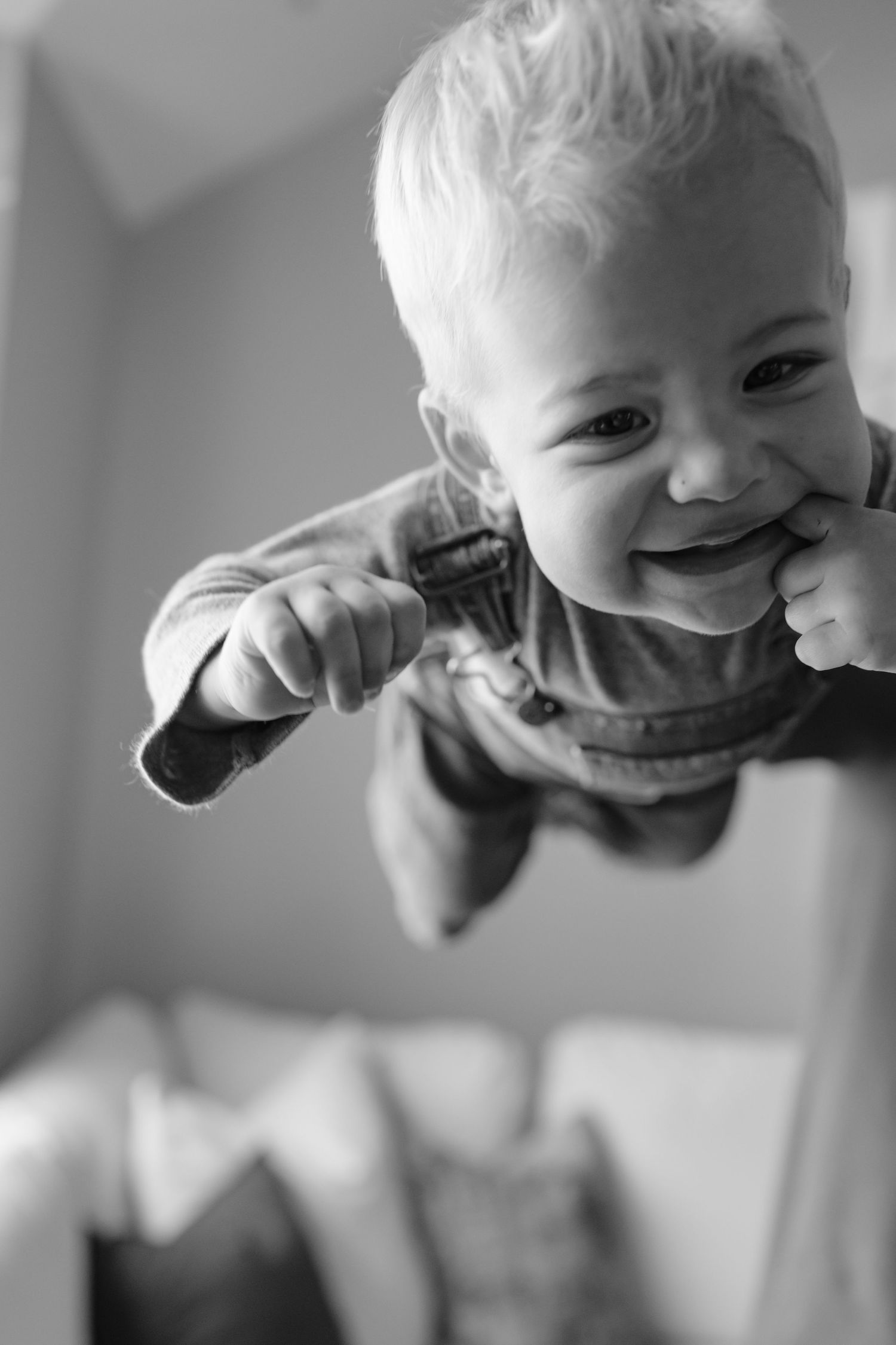 Black and white close-up sequence of a child making silly faces.