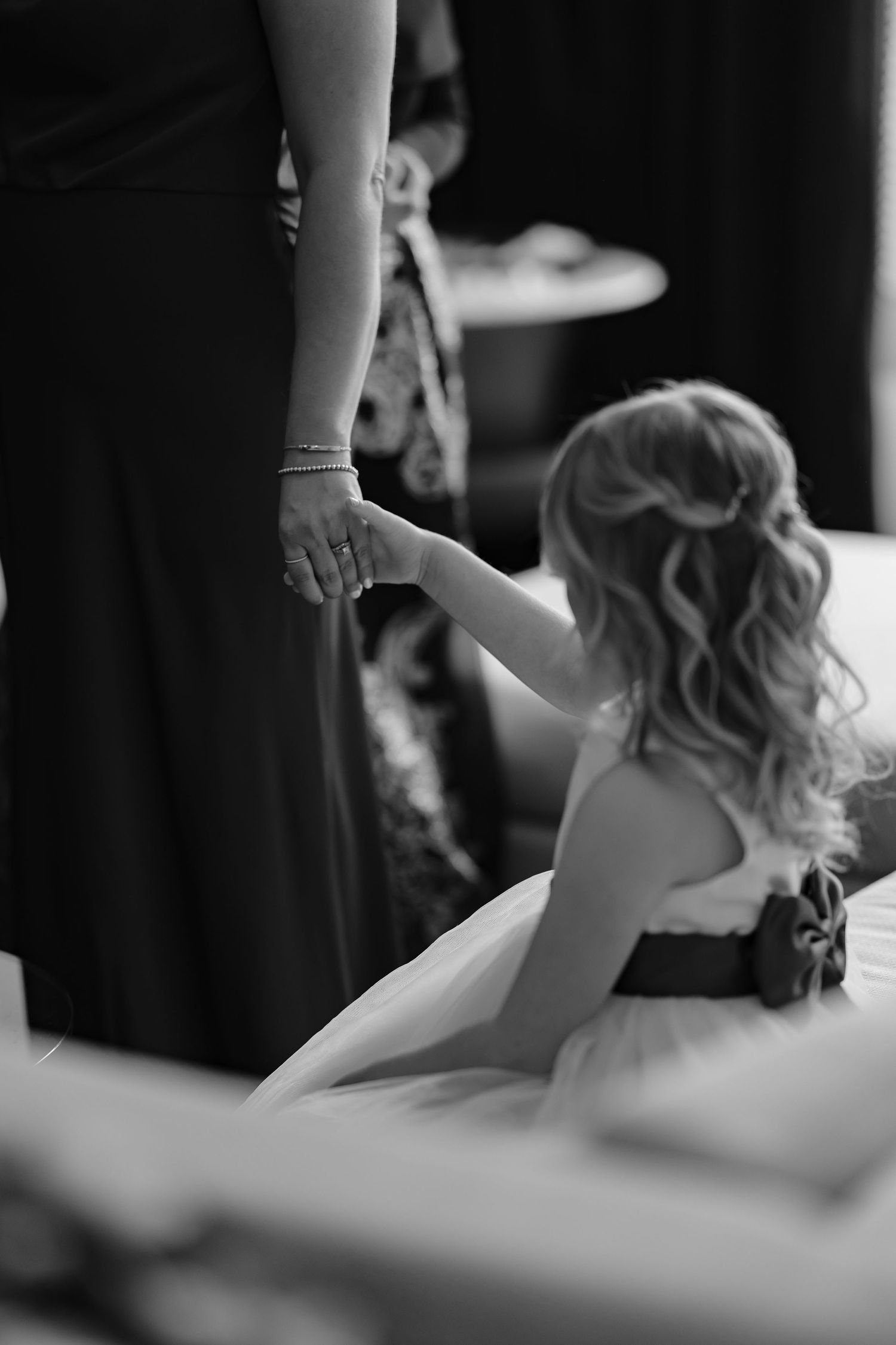 Black and white image of wedding preparation moments with flowing fabric and movement.