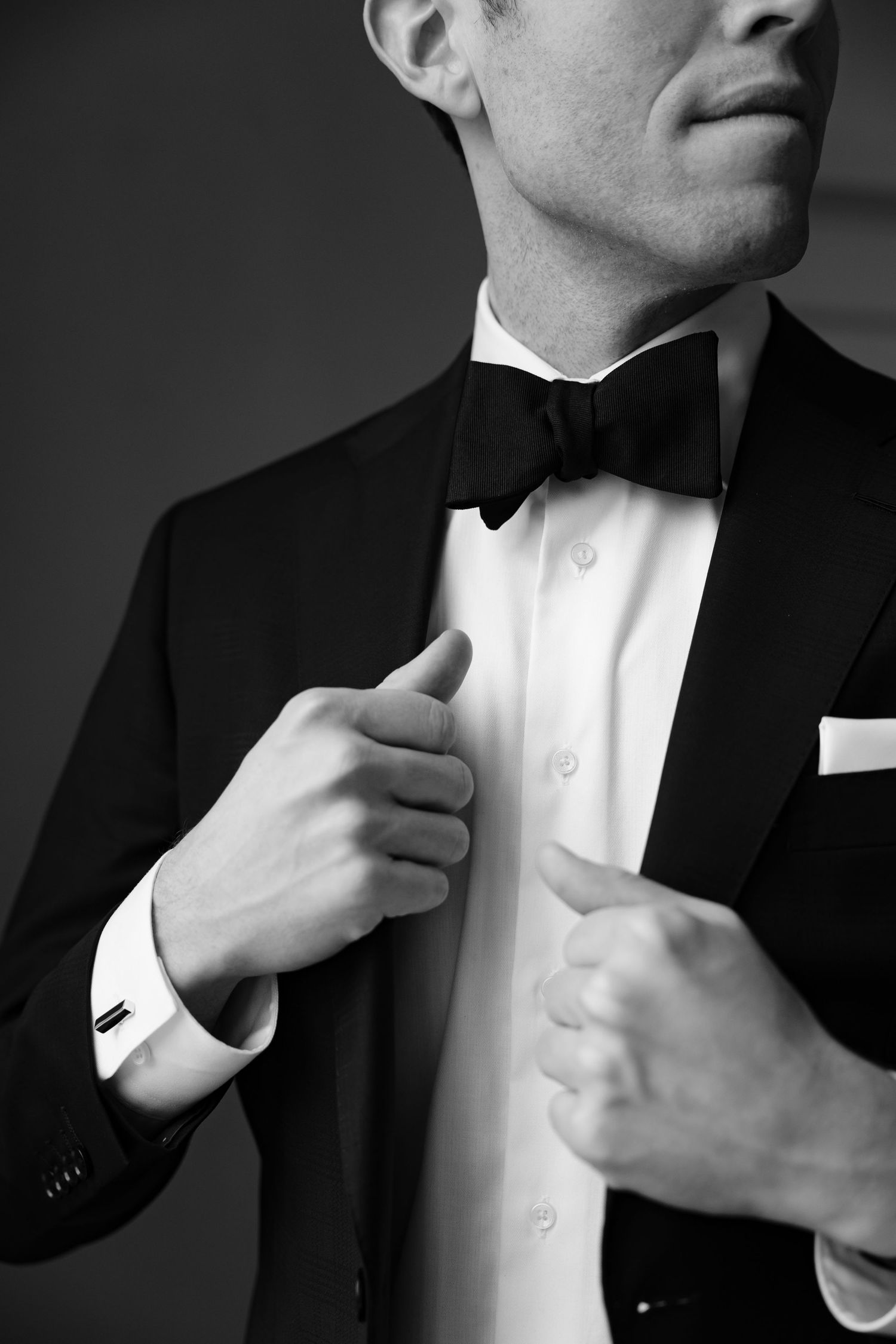 Close-up of formal black tuxedo with bow tie and white dress shirt.