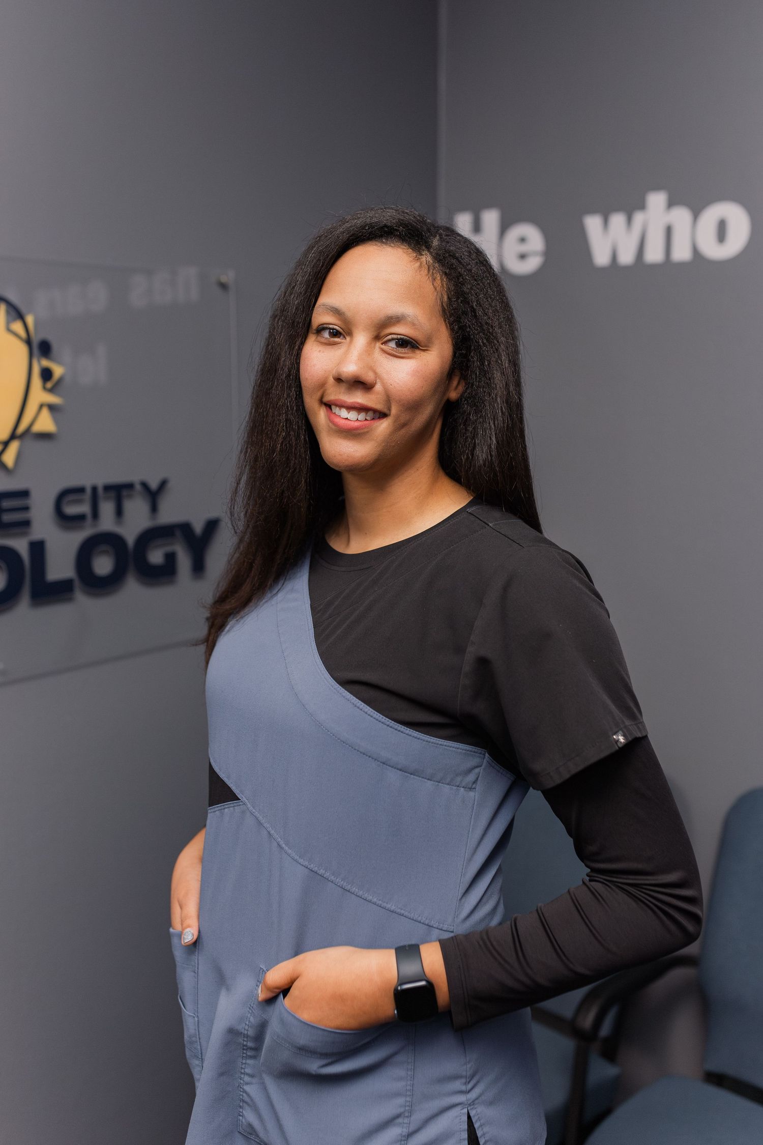 black woman posing for headshot inside her audiology business