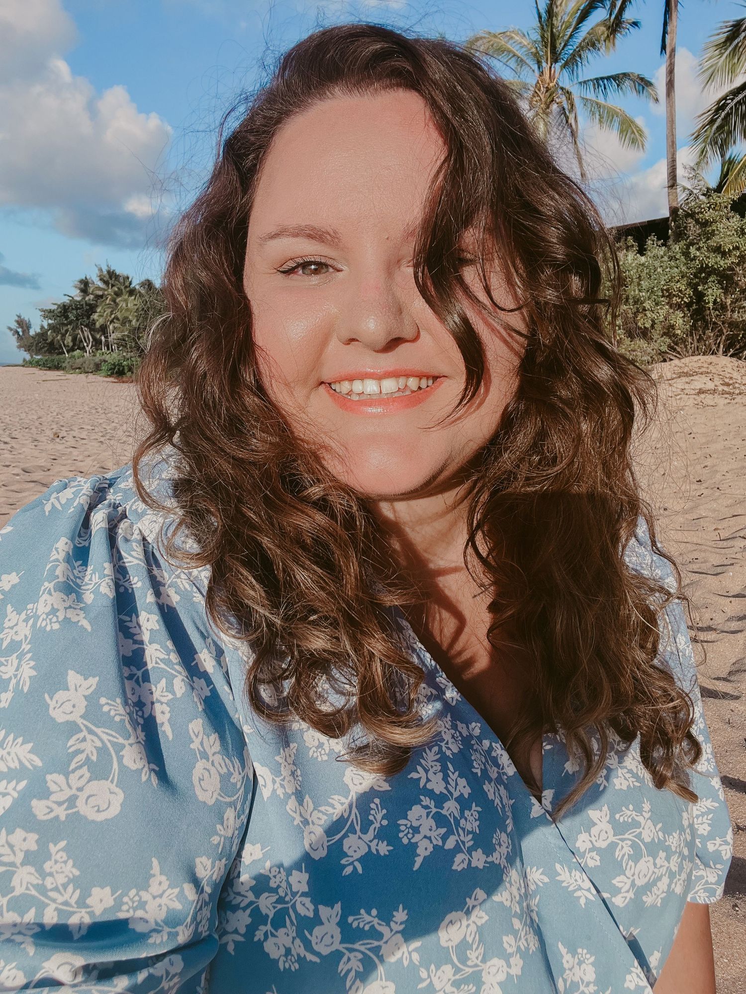 white girl smiles for a selfie on the beach in Hawaii