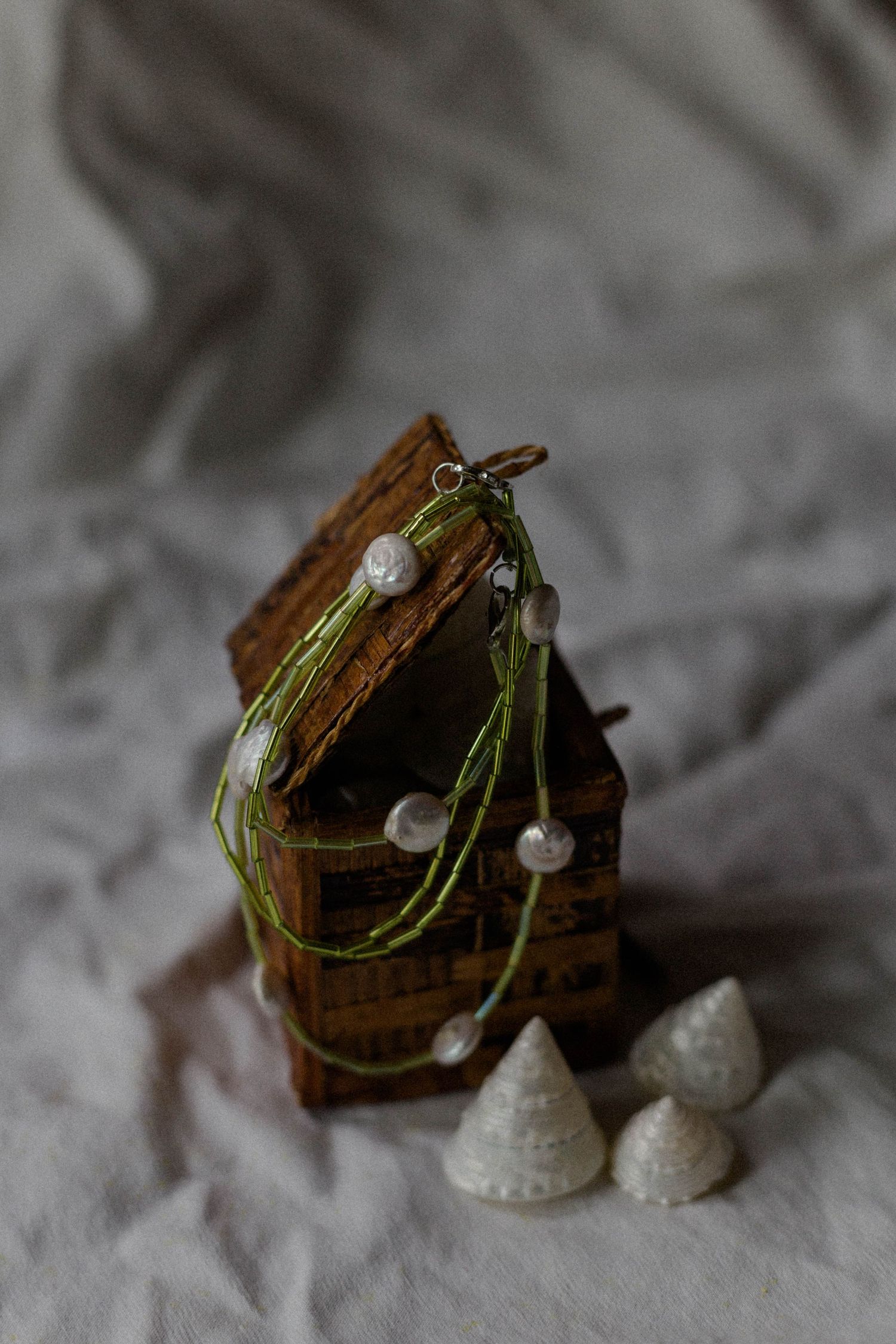 handmade necklace placed on rattan box for jewelry business branding photoshoot