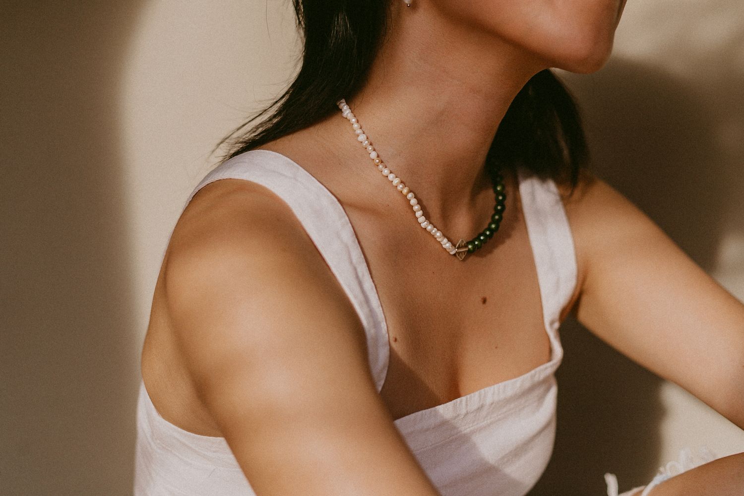 asian woman poses with jewelry for a branding photoshoot for a jewelry business in galveston Texas
