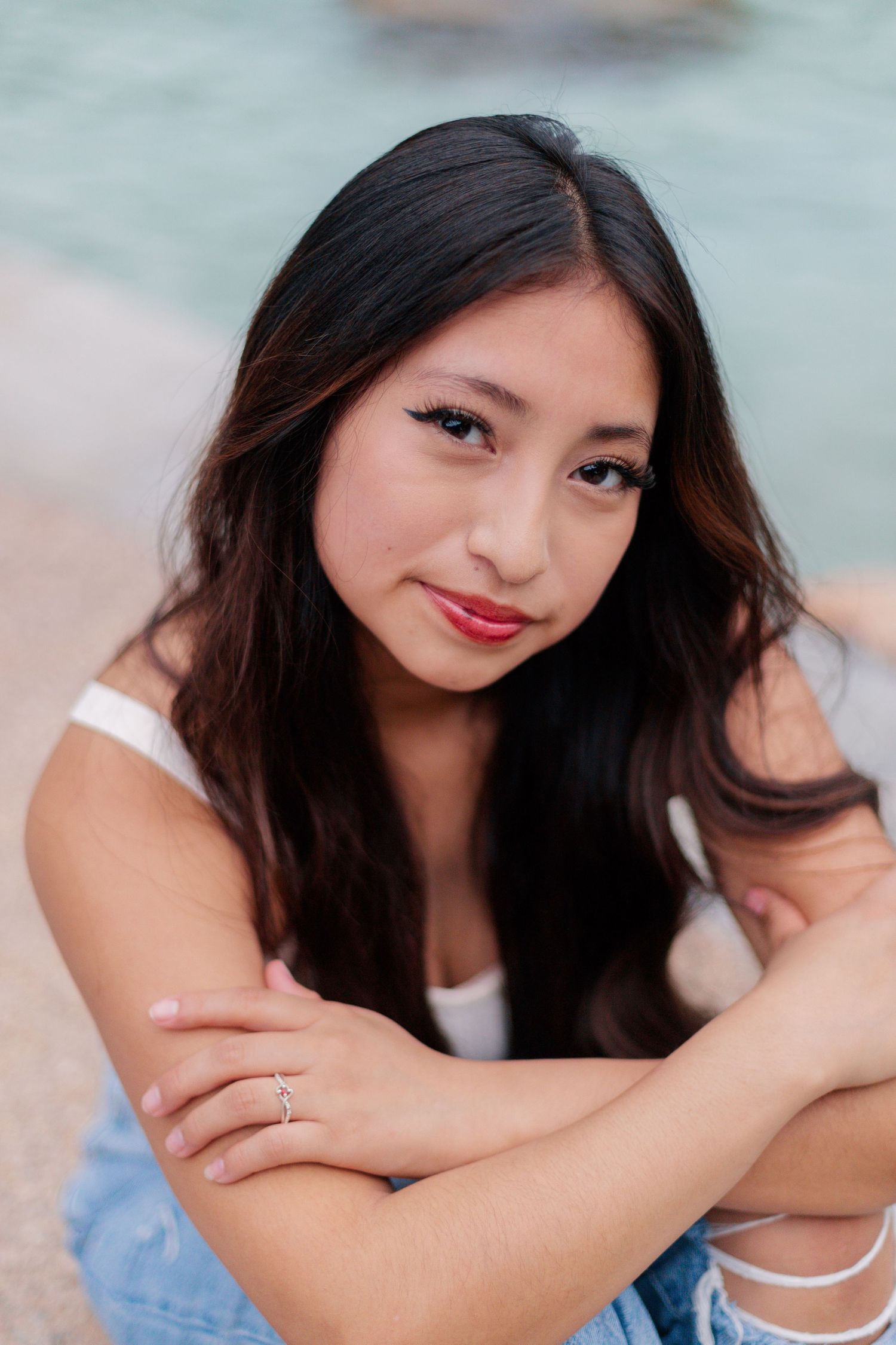 hispanic high school senior girl smiles softly for headshot in senior photos in league city Texas