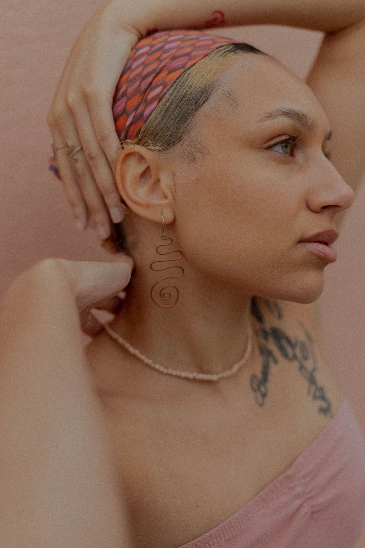mixed race model poses for jewelry business branding product photo session