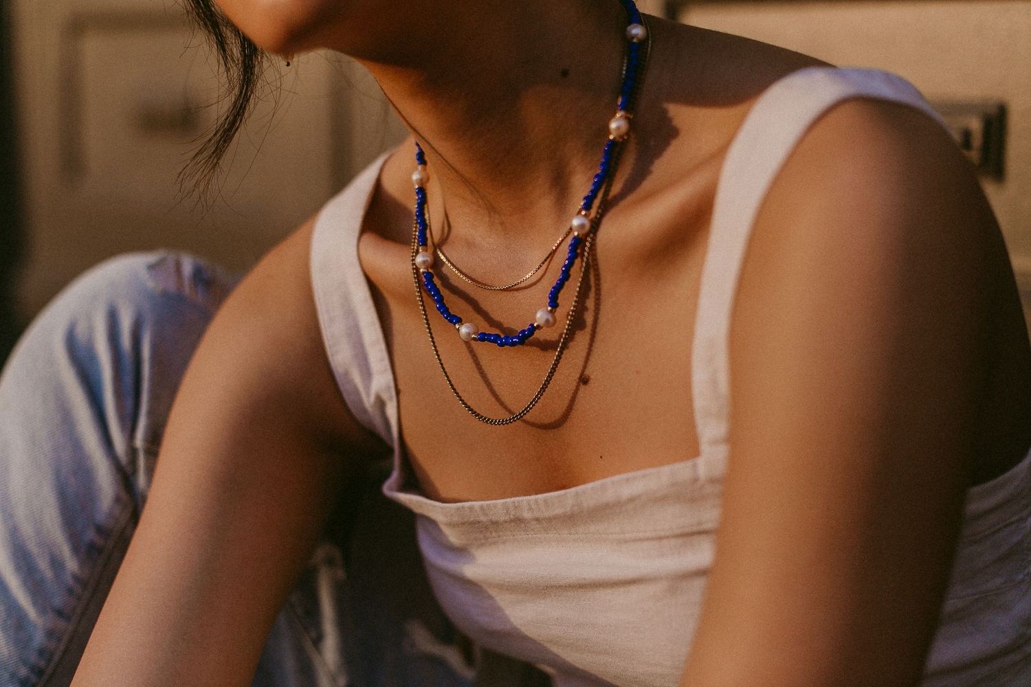 asian woman poses with jewelry for a branding photoshoot for a jewelry business in galveston Texas