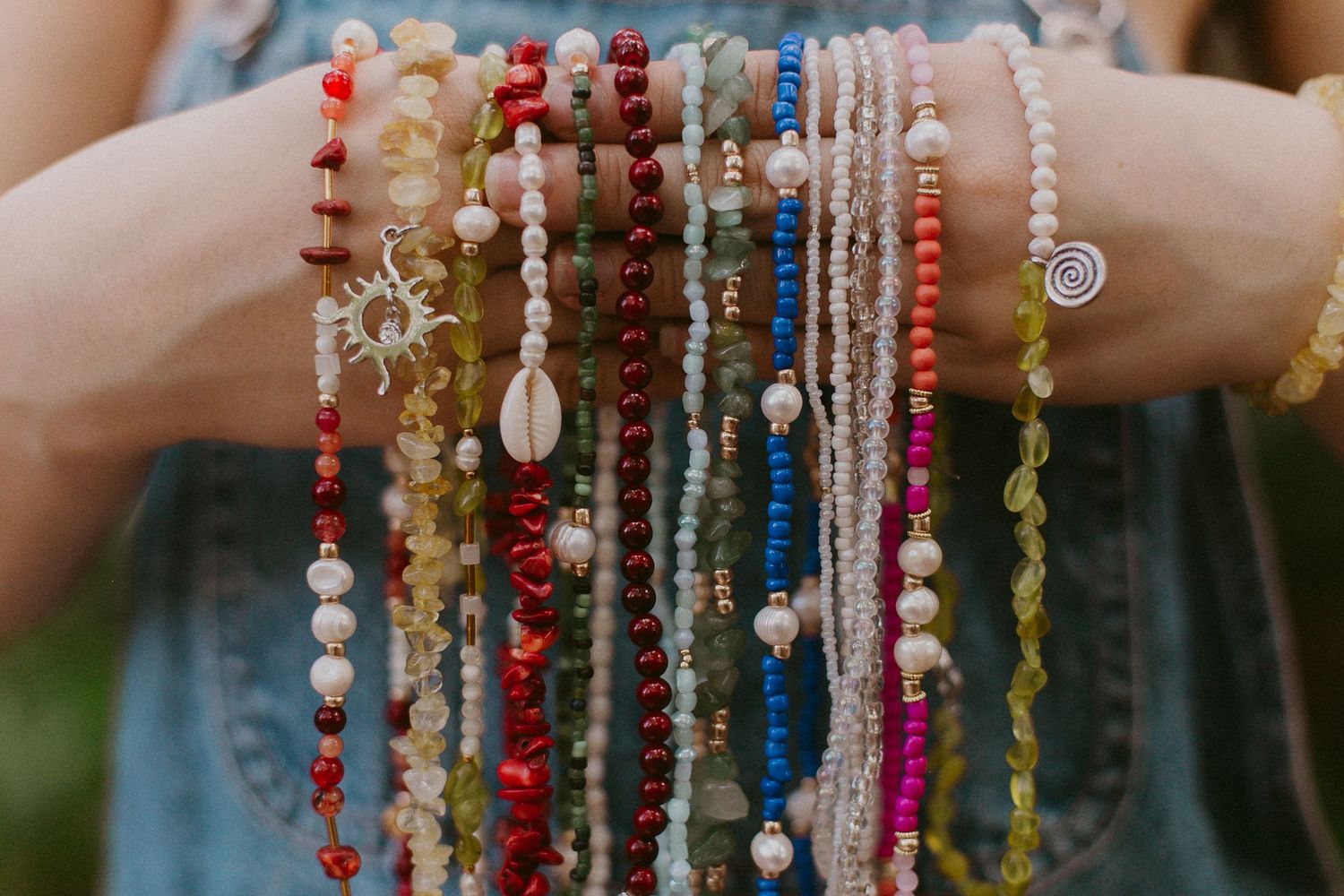 woman holds necklaces in a branding photoshoot for jewelry business