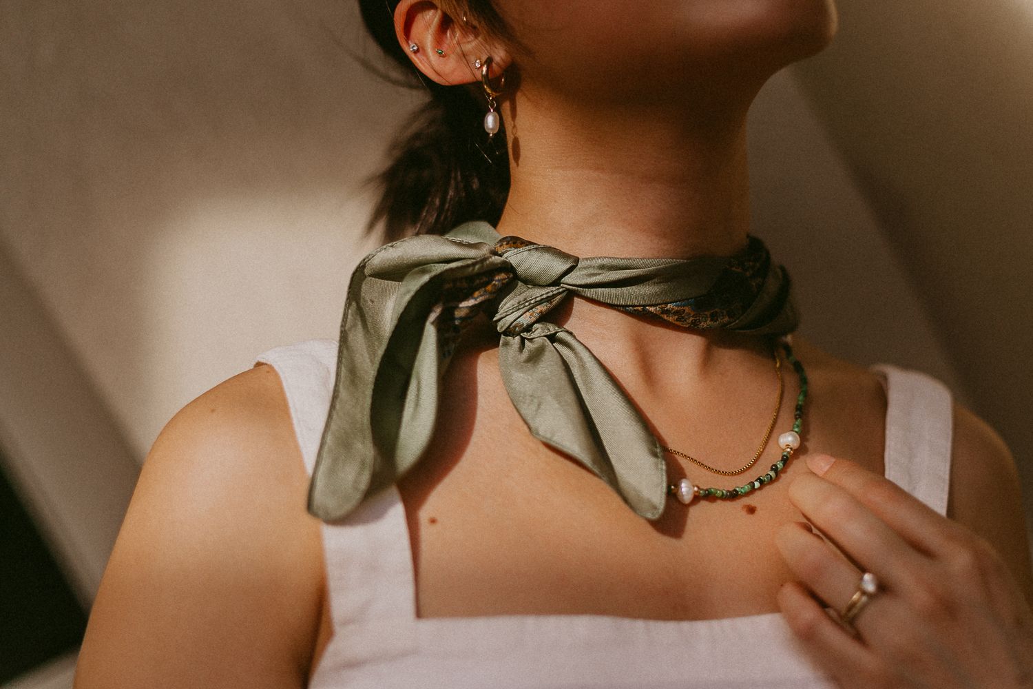 asian woman poses with jewelry for a branding photoshoot for a jewelry business in galveston Texas