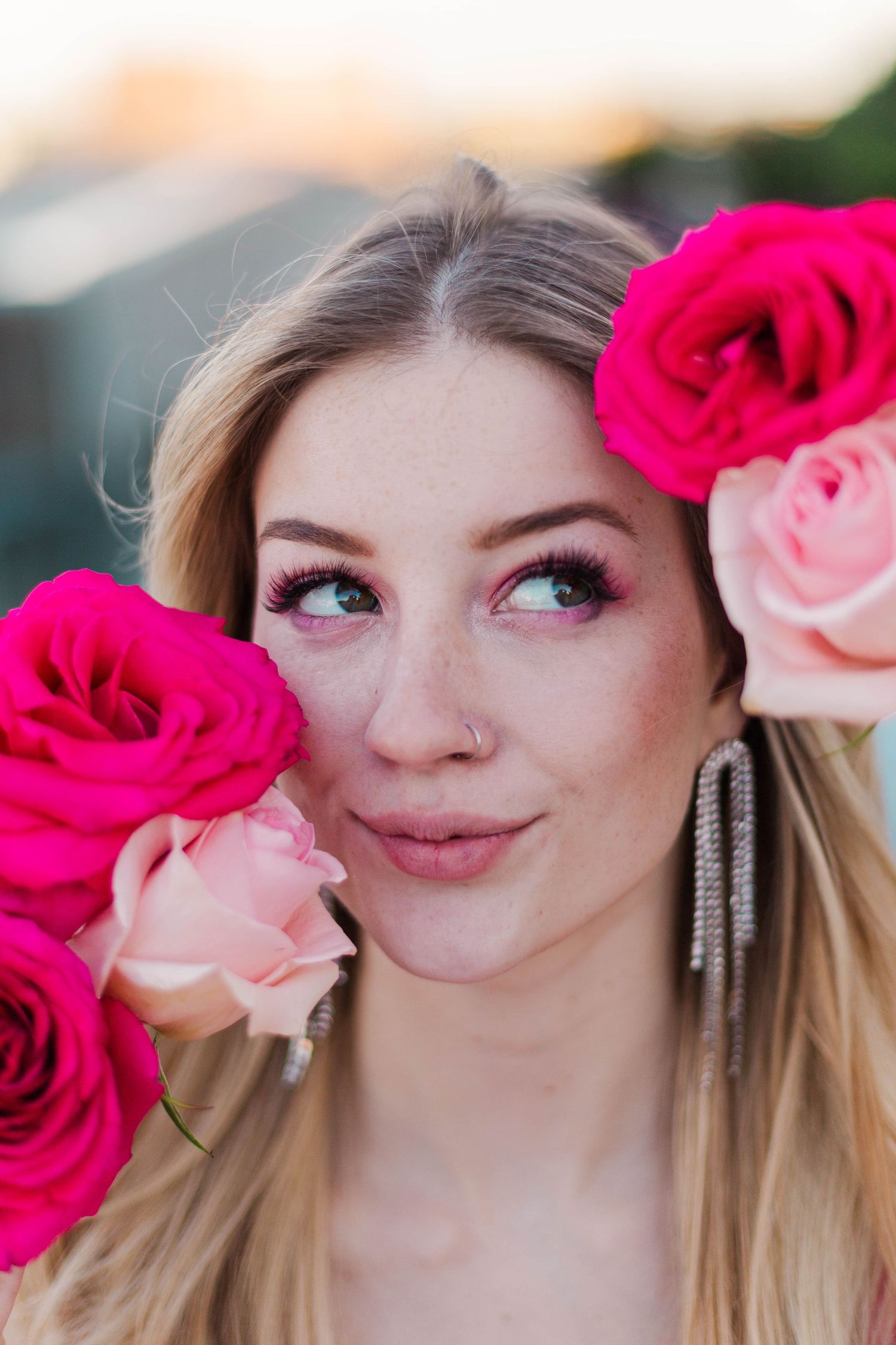 blonde model posing at POST Houston with red and pink roses at a barbie theme photoshoot