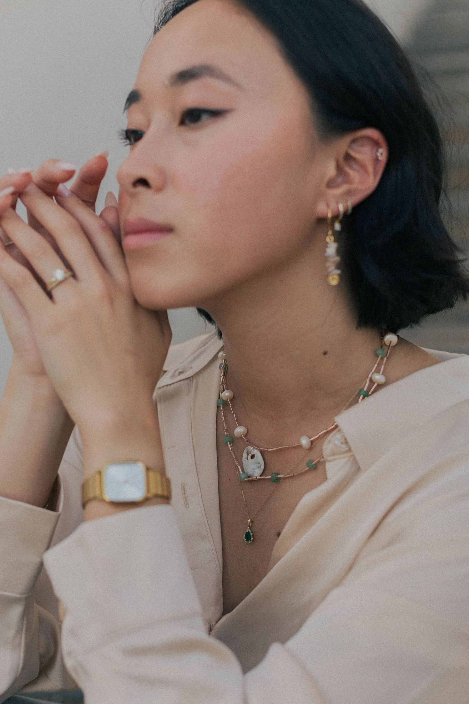asian woman poses with jewelry for a branding photoshoot for a jewelry business in houston Texas